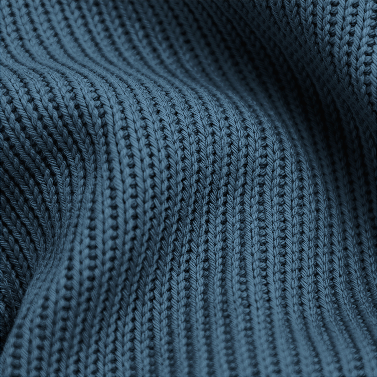 Gros plan sur un tissu tricot côtelé bleu foncé avec des plis doux et une texture.