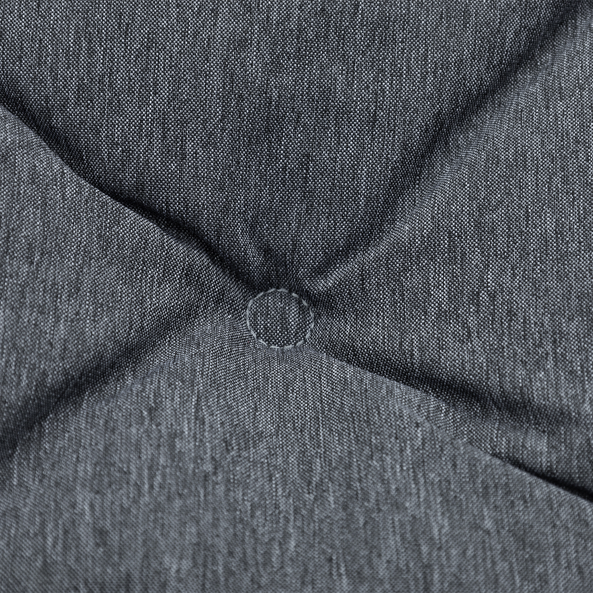 Close-up of gray fabric upholstery with button tufting.