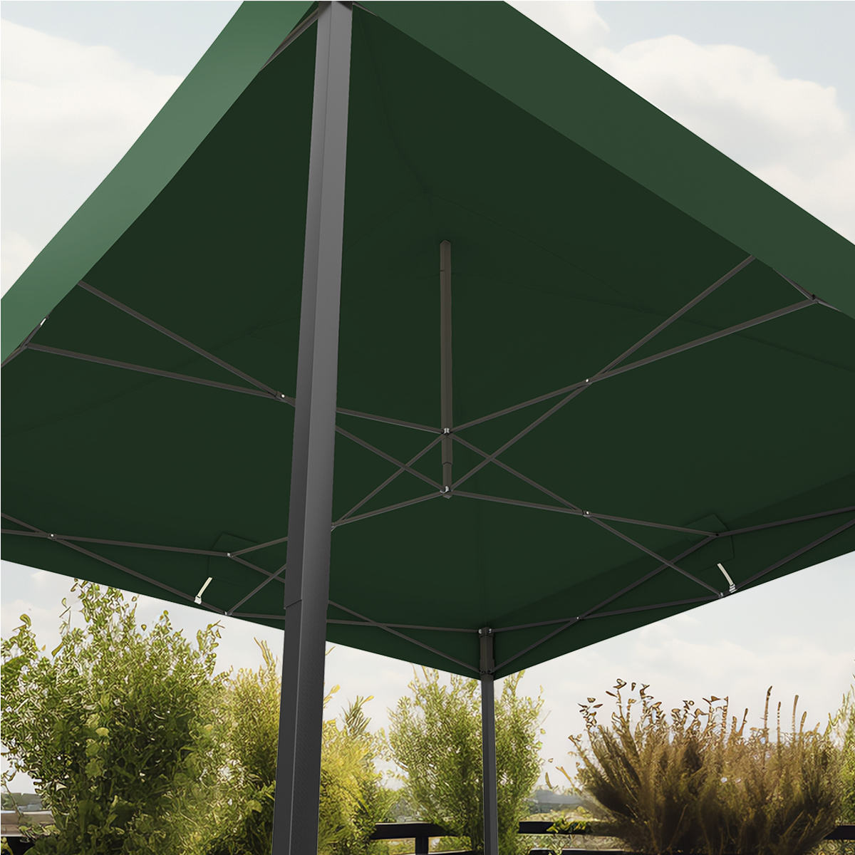Dark green umbrella with gray frame over lush green foliage.