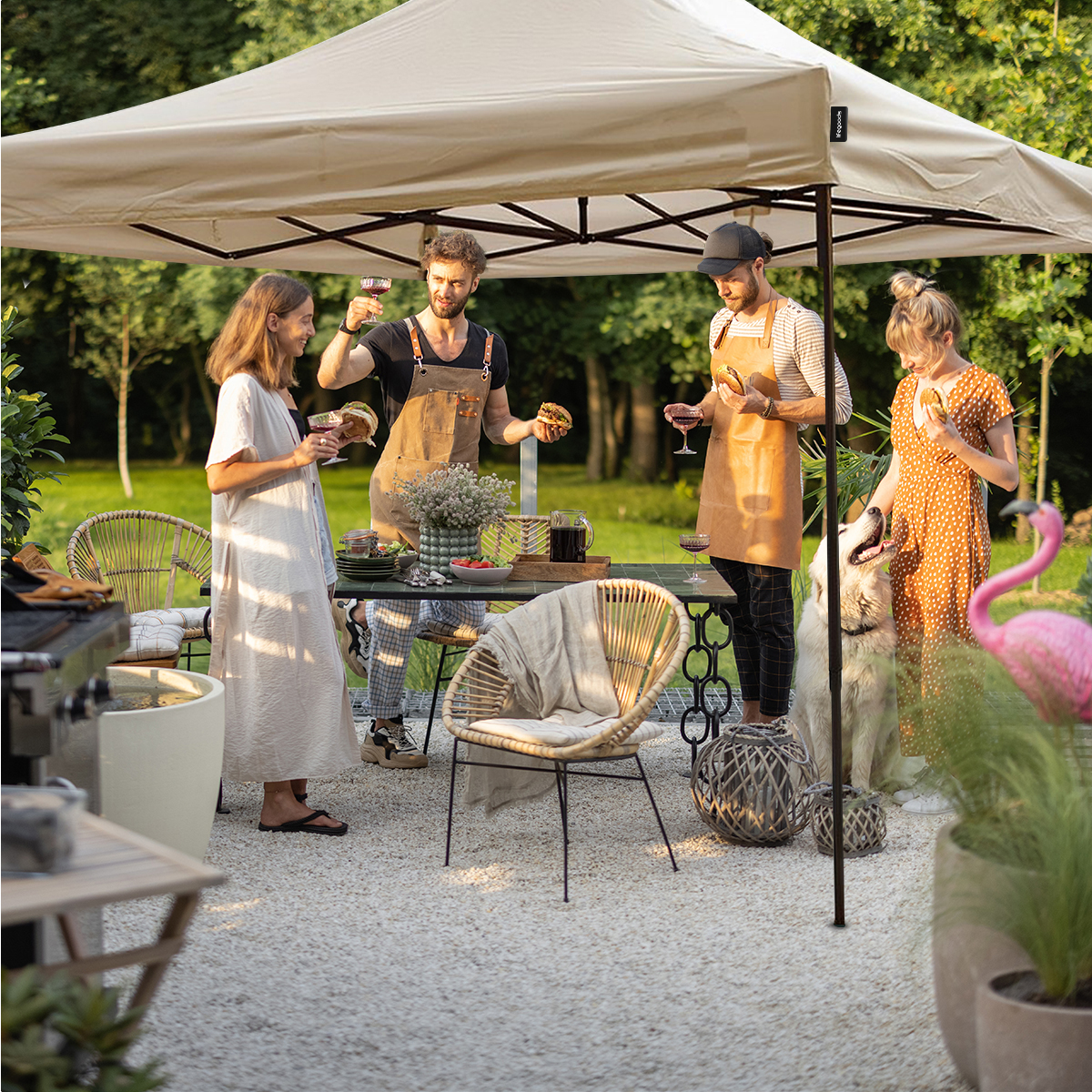 People and dog under canopy, food on table, garden furniture.
