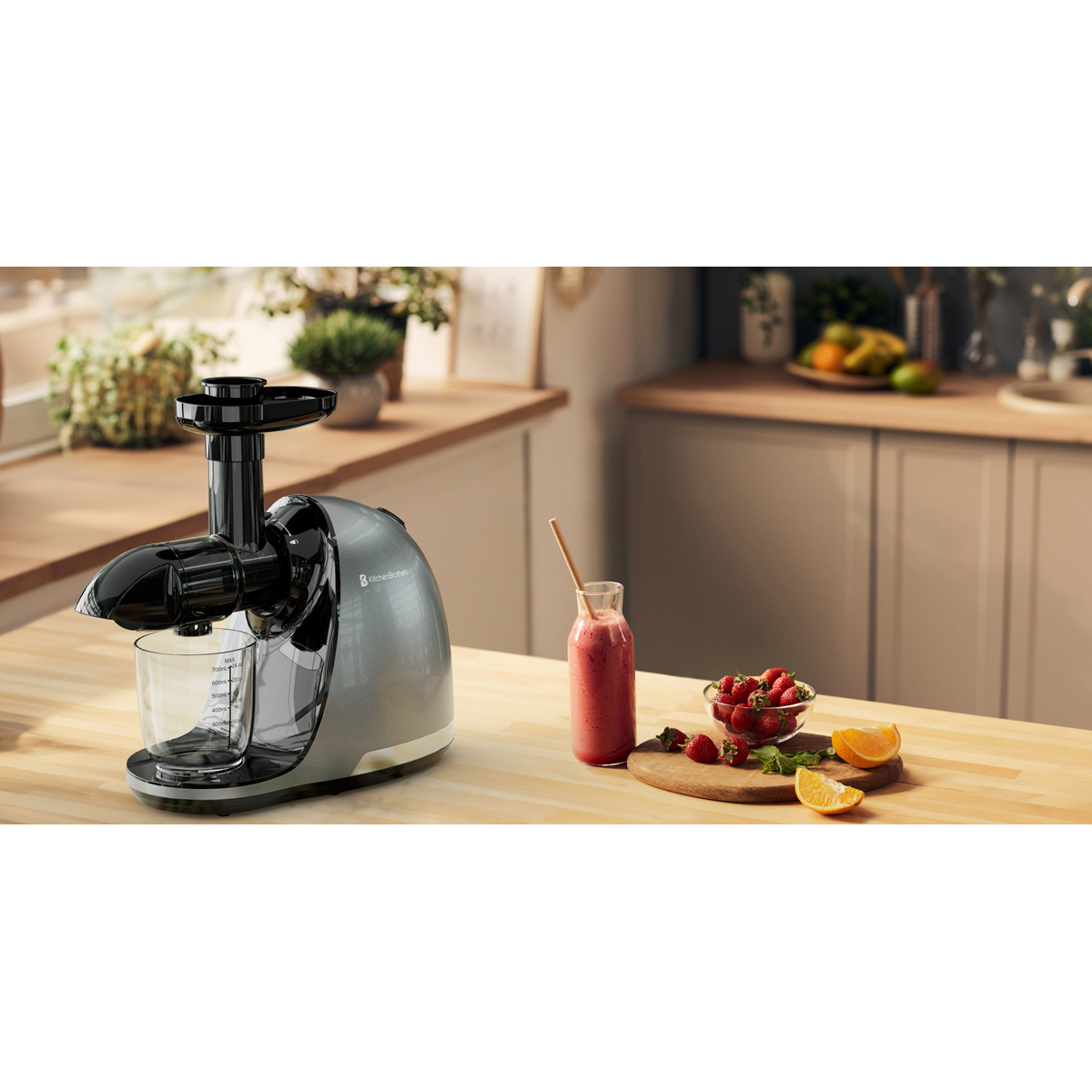 A silver juicer sits on a wooden counter next to a smoothie, strawberries, and orange slices.