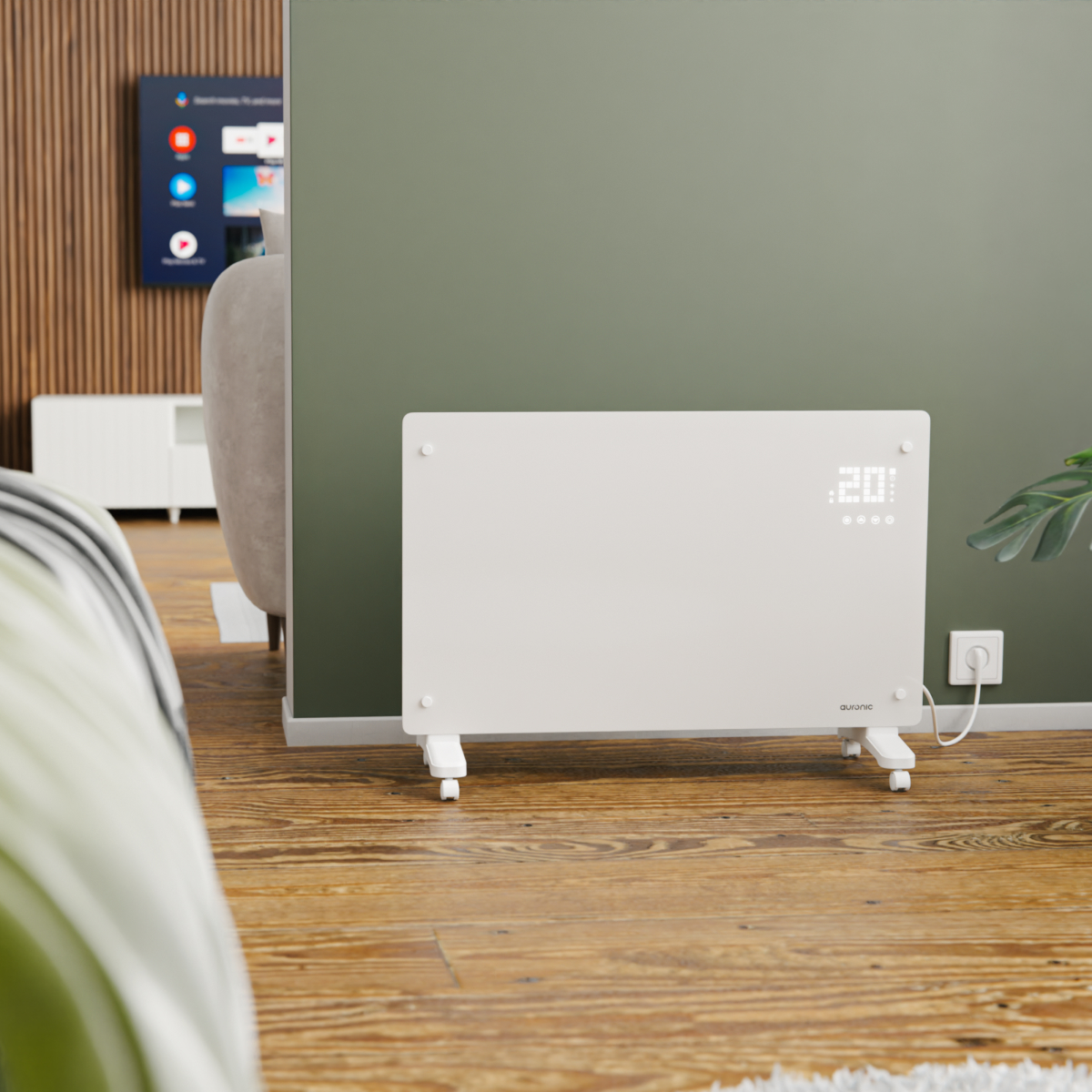 Een witte verwarming op wielen staat op een houten vloer voor een groene muur.