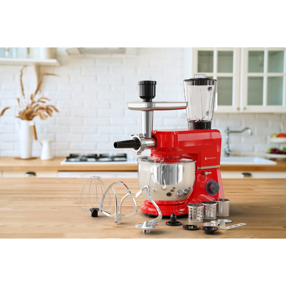 Een rode keukenmachine met vleesmolen en blender op een houten tafel.
