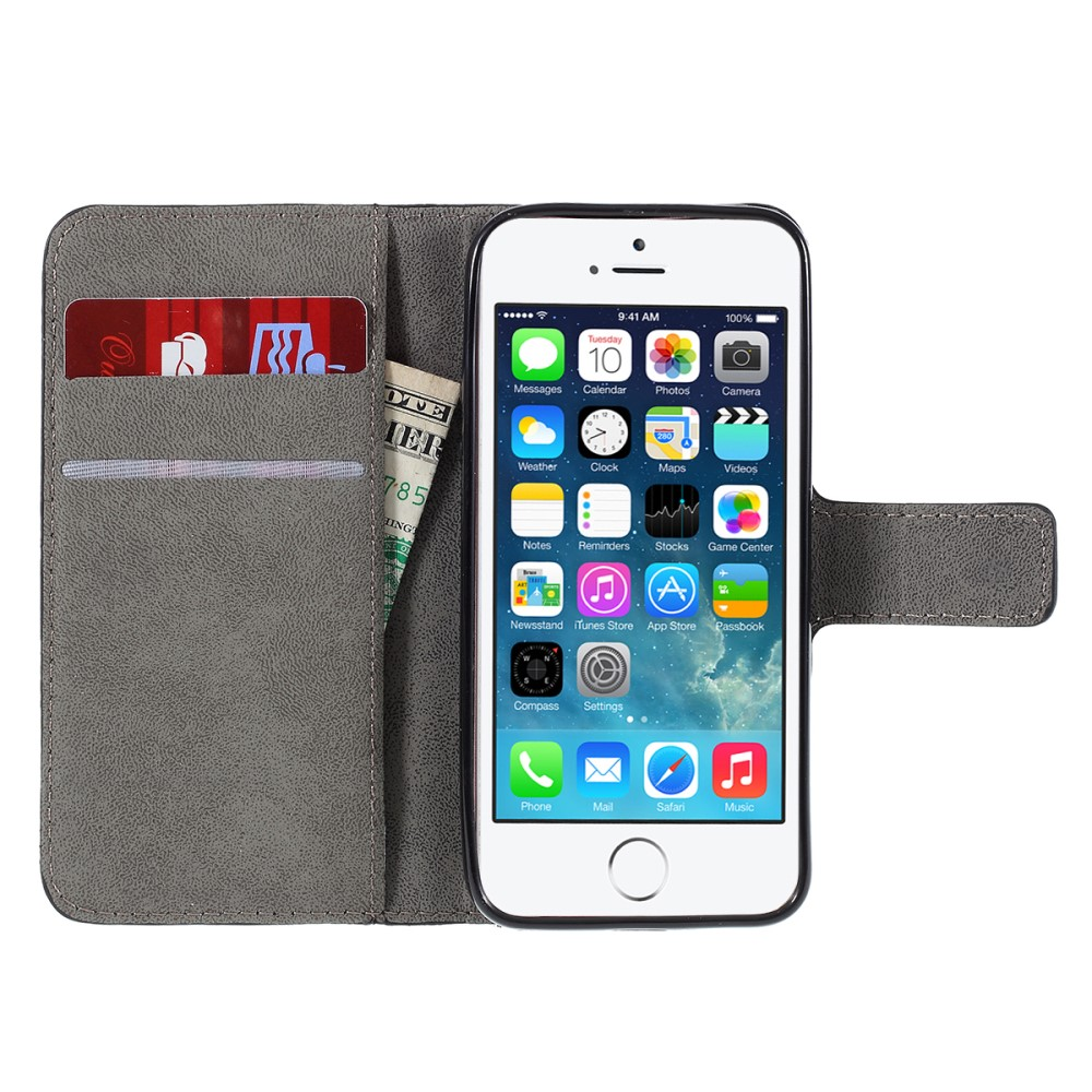 Étui portefeuille gris tenant cartes et espèces, avec un iPhone affichant des apps.
