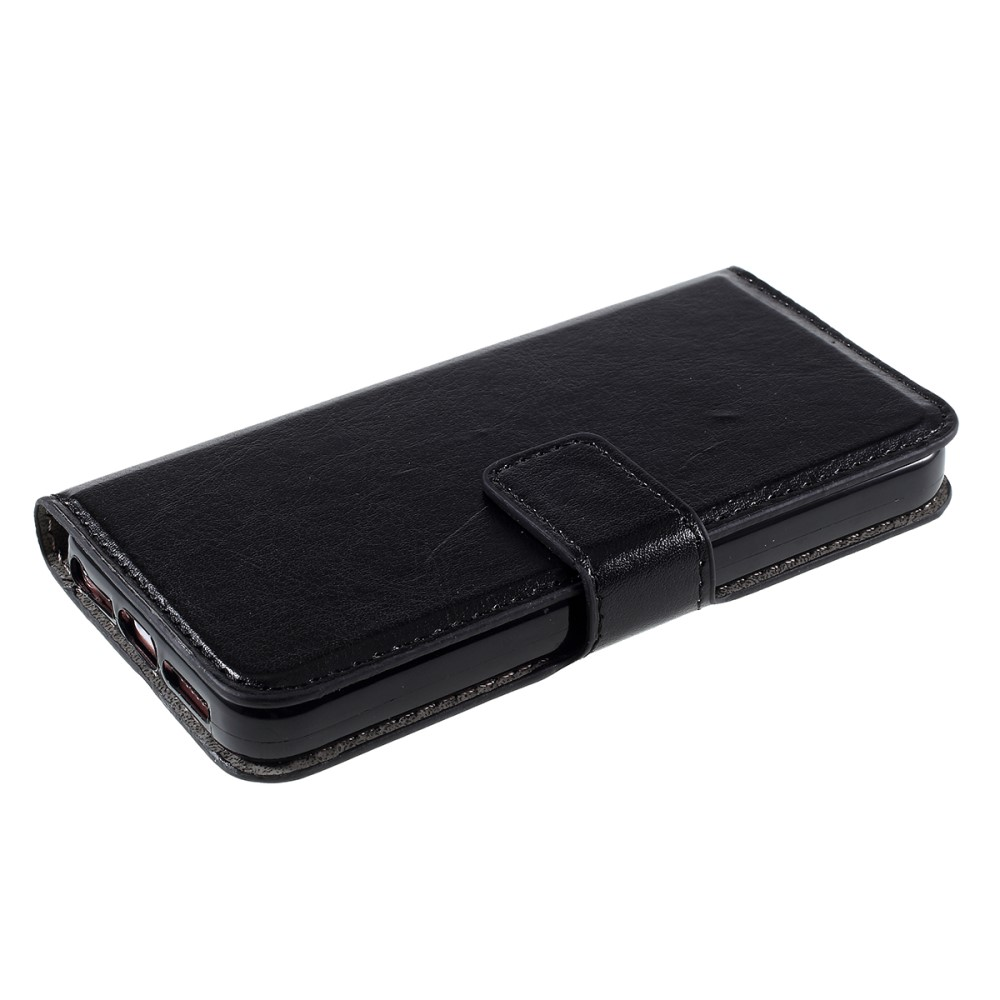 Étui portefeuille noir en cuir pour smartphone, posé sur fond blanc.