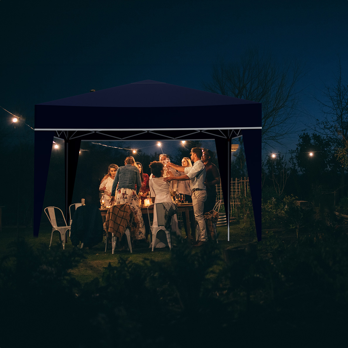 People toast under a dark gazebo with string lights, outdoors at night.