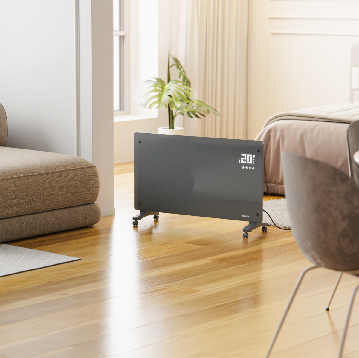A dark heater with wheels stands on a wooden floor next to a sofa and a bed.
