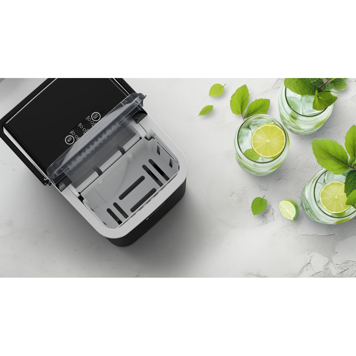 A black ice maker with its lid open, next to three glasses with ice, lime slices, and mint.