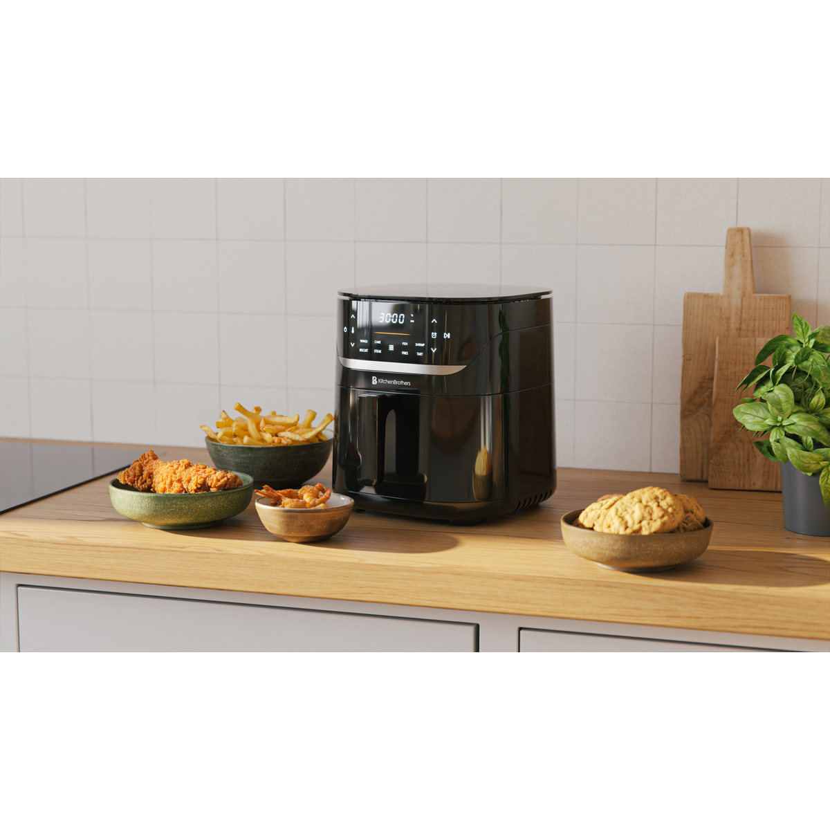 Black air fryer with fried chicken, fries, shrimp, and cookies.