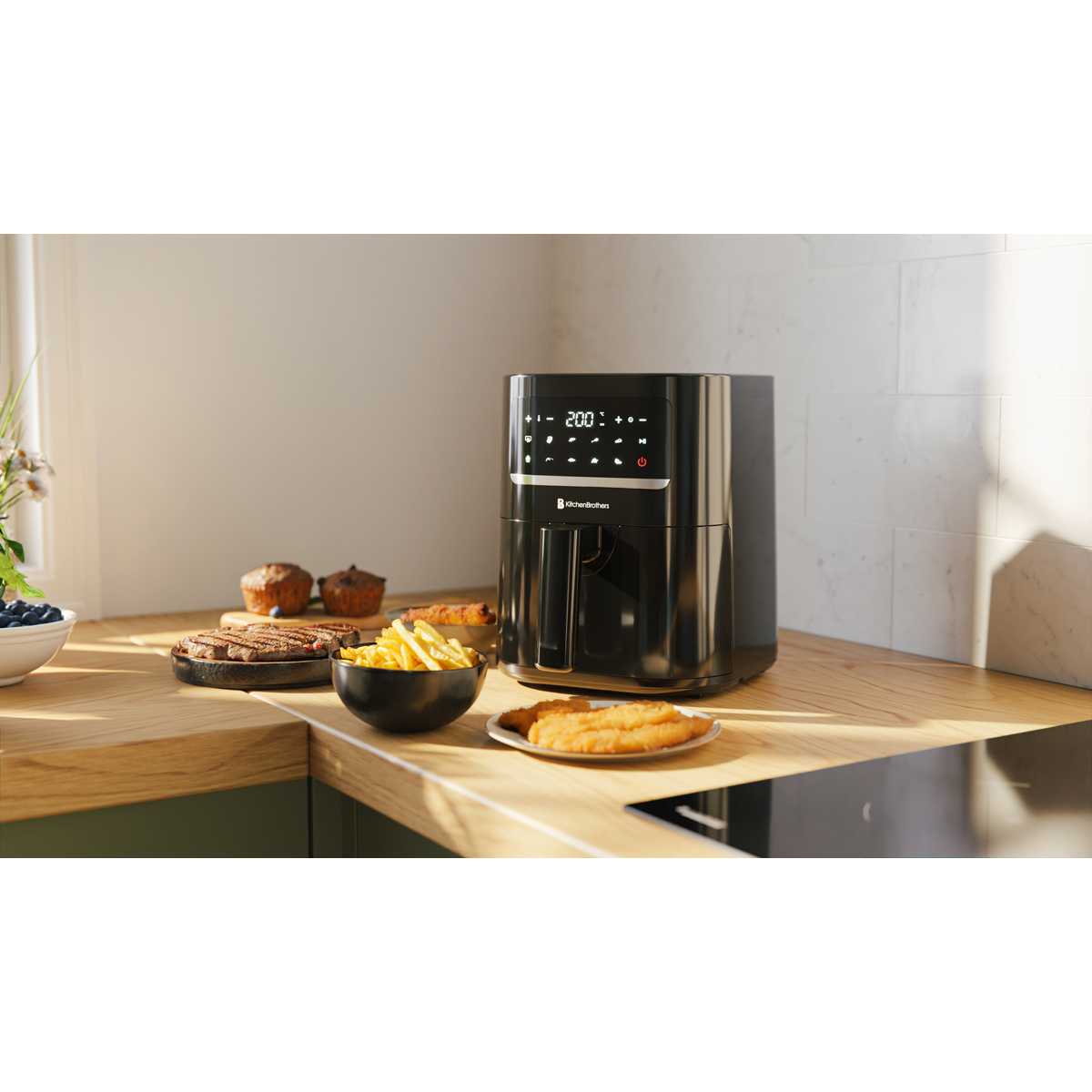 Black air fryer on a counter with steak, fries, muffins, and fish sticks.