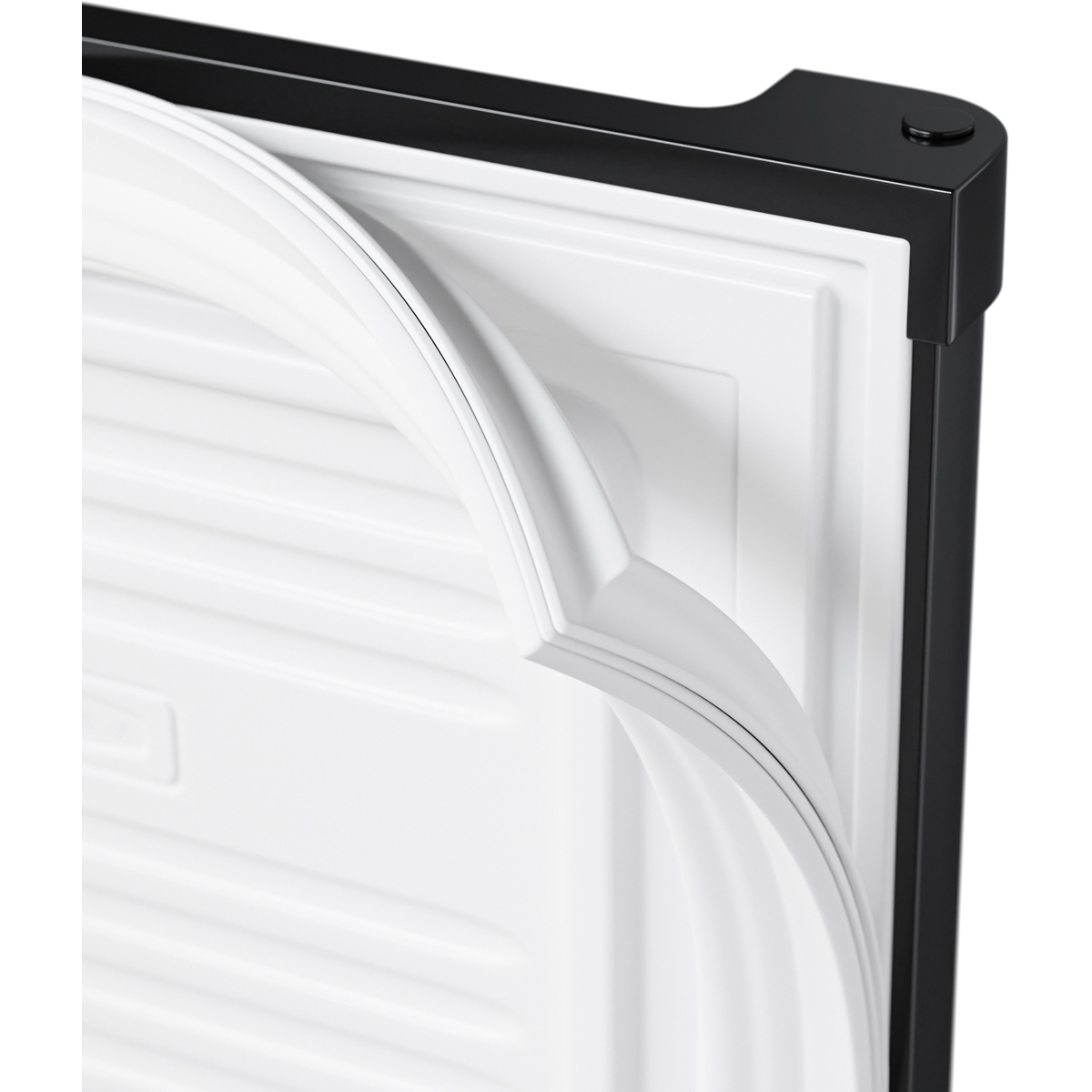 Close-up of a white rubber seal on a black refrigerator door.