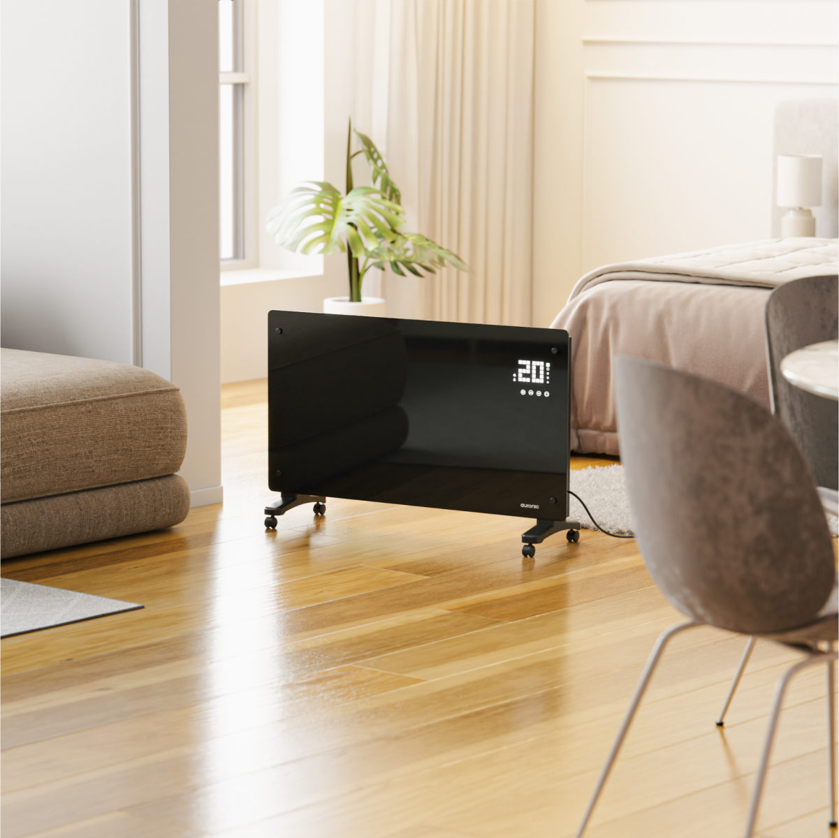 A black electric heater with wheels stands on a wooden floor near a bed.