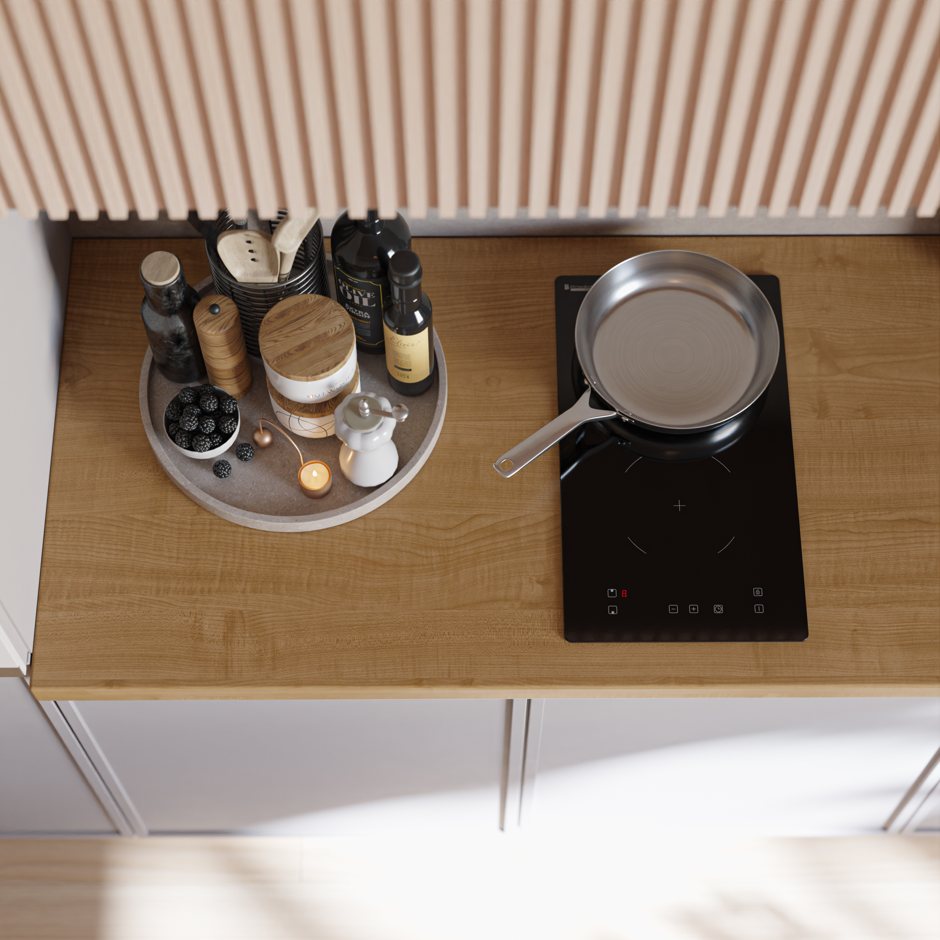 A silver frying pan on a black stovetop, next to a tray with berries and spices.