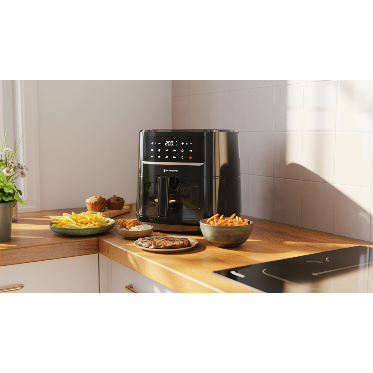 Black air fryer with french fries, steak, muffin and chicken.