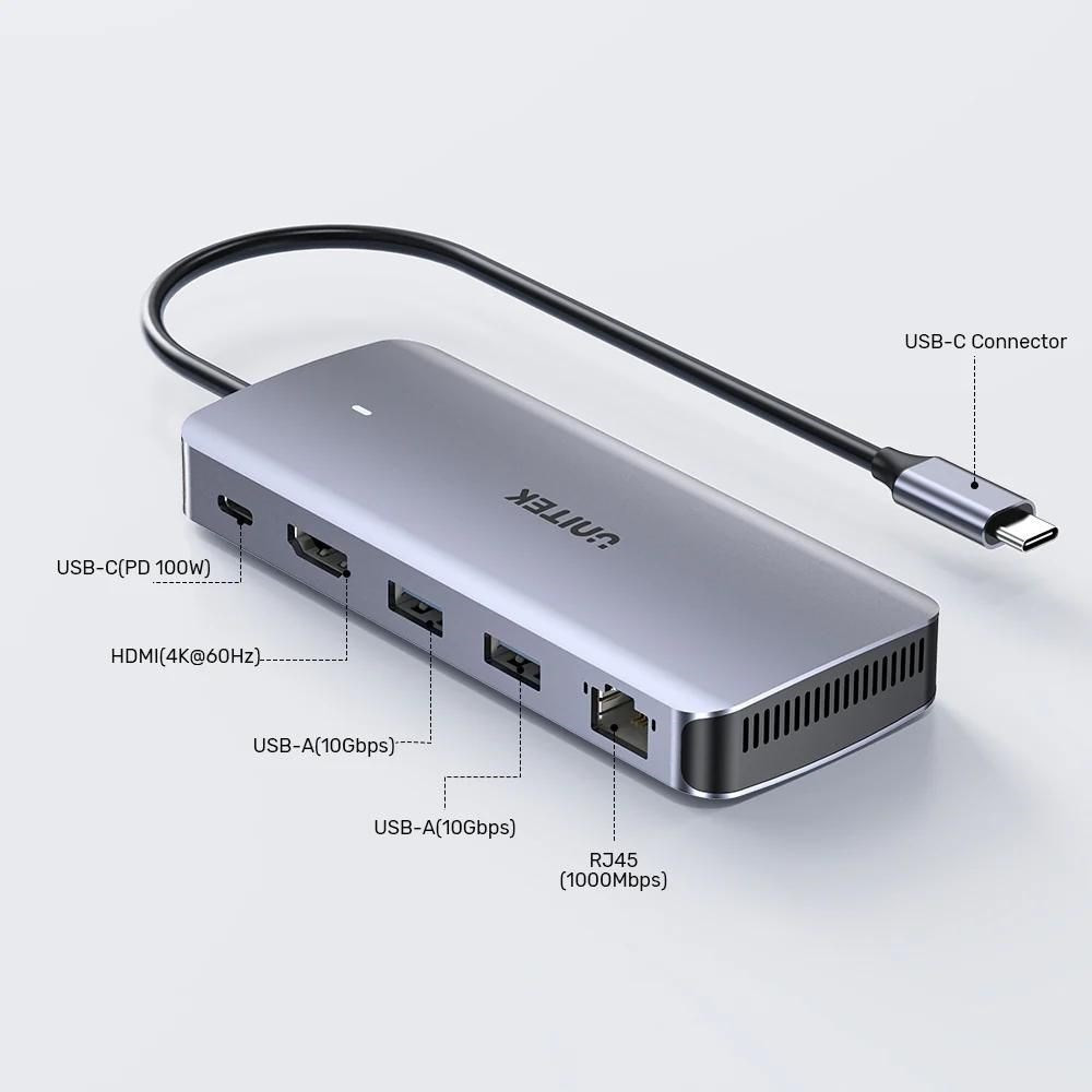 Szara przystawka USB-C z HDMI, portami USB-A i złączem RJ45.