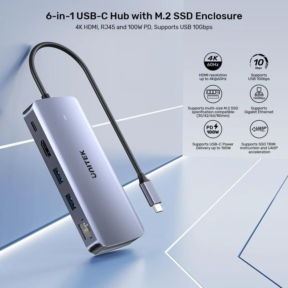 Szary hub USB-C 6 w 1 z obudową SSD M.2 i wieloma portami.
