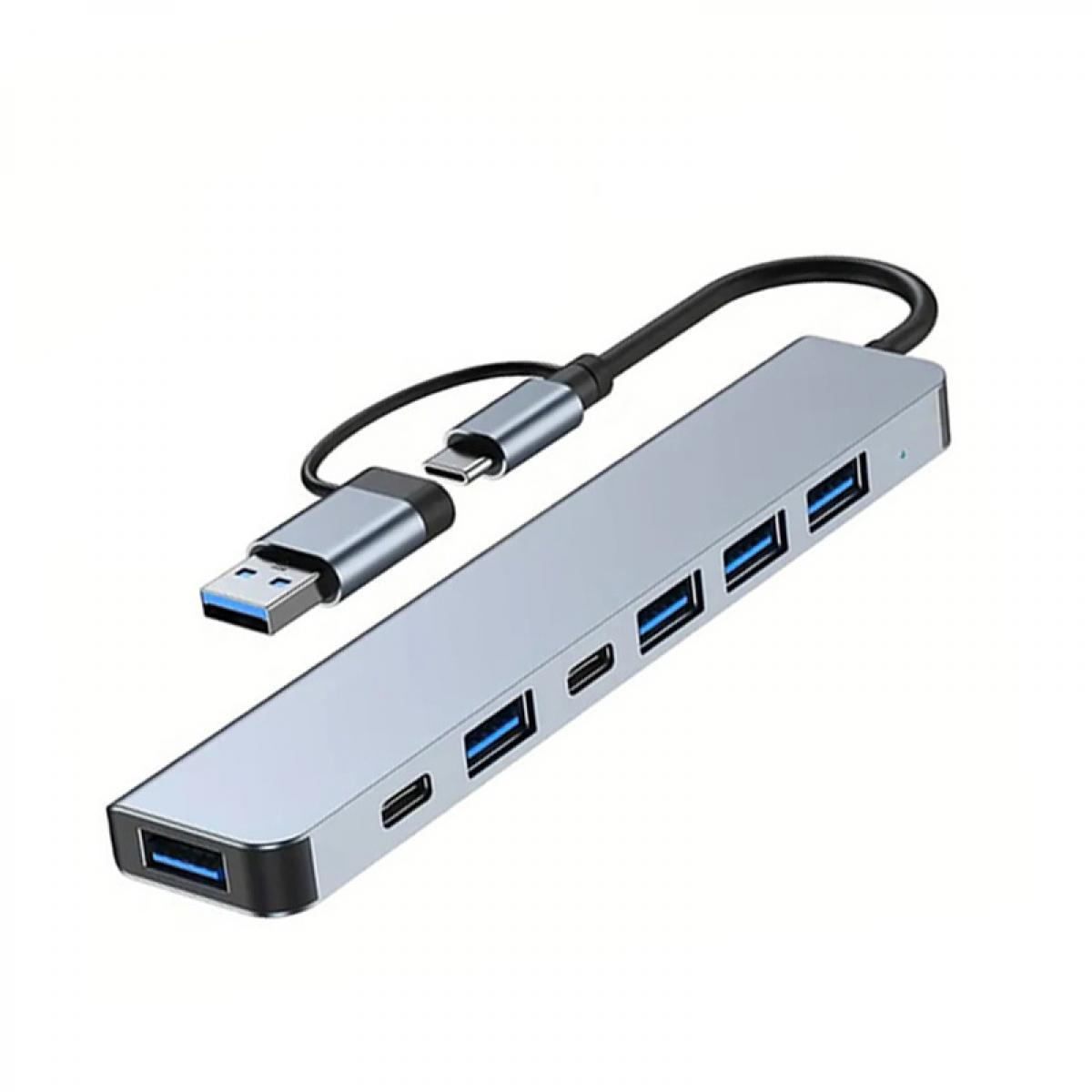 Ein grauer USB-C-Hub mit mehreren Anschlüssen und einem angeschlossenen USB-A-Kabel.