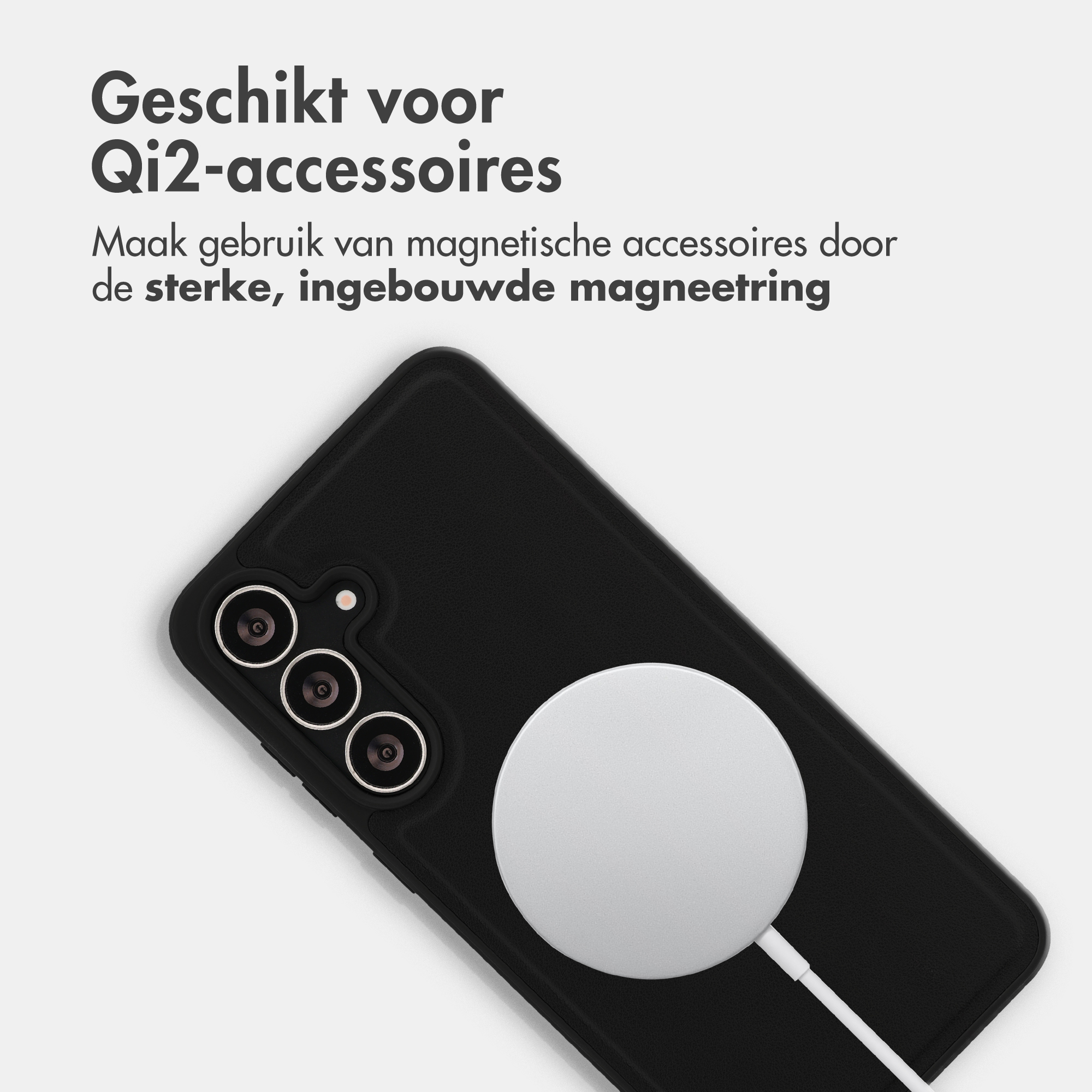 Black phone with three cameras and a white Qi2 charger.