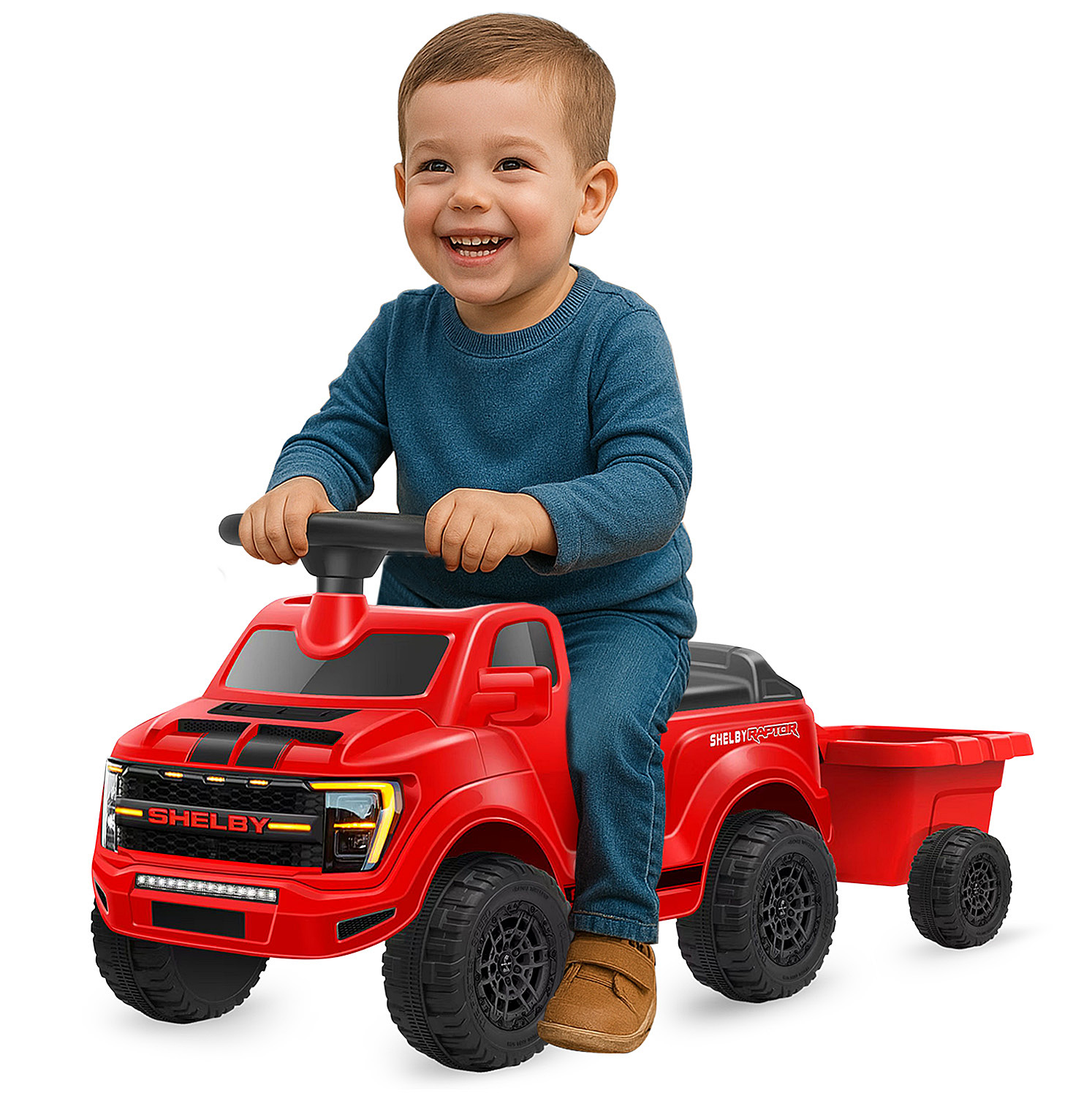 Un bimbo siede su un camioncino giocattolo rosso con rimorchio.