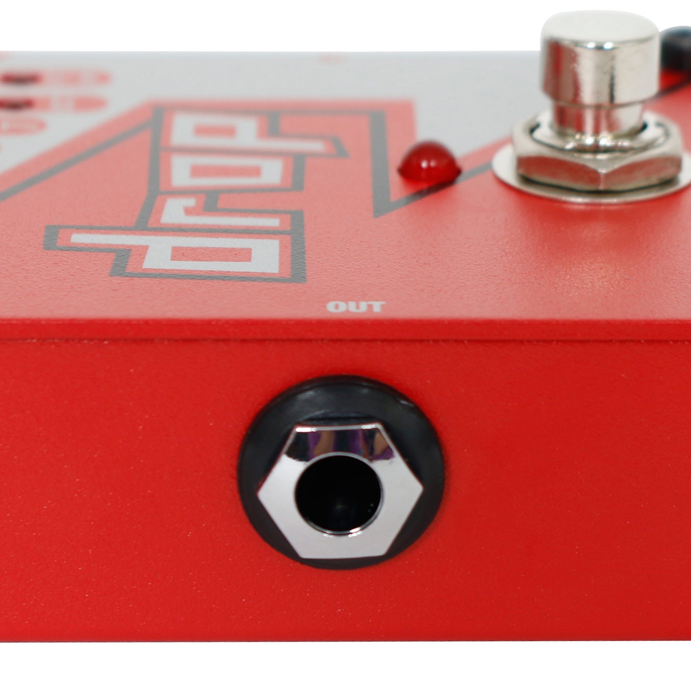 Red guitar effect pedal close-up with silver footswitch and red LED.