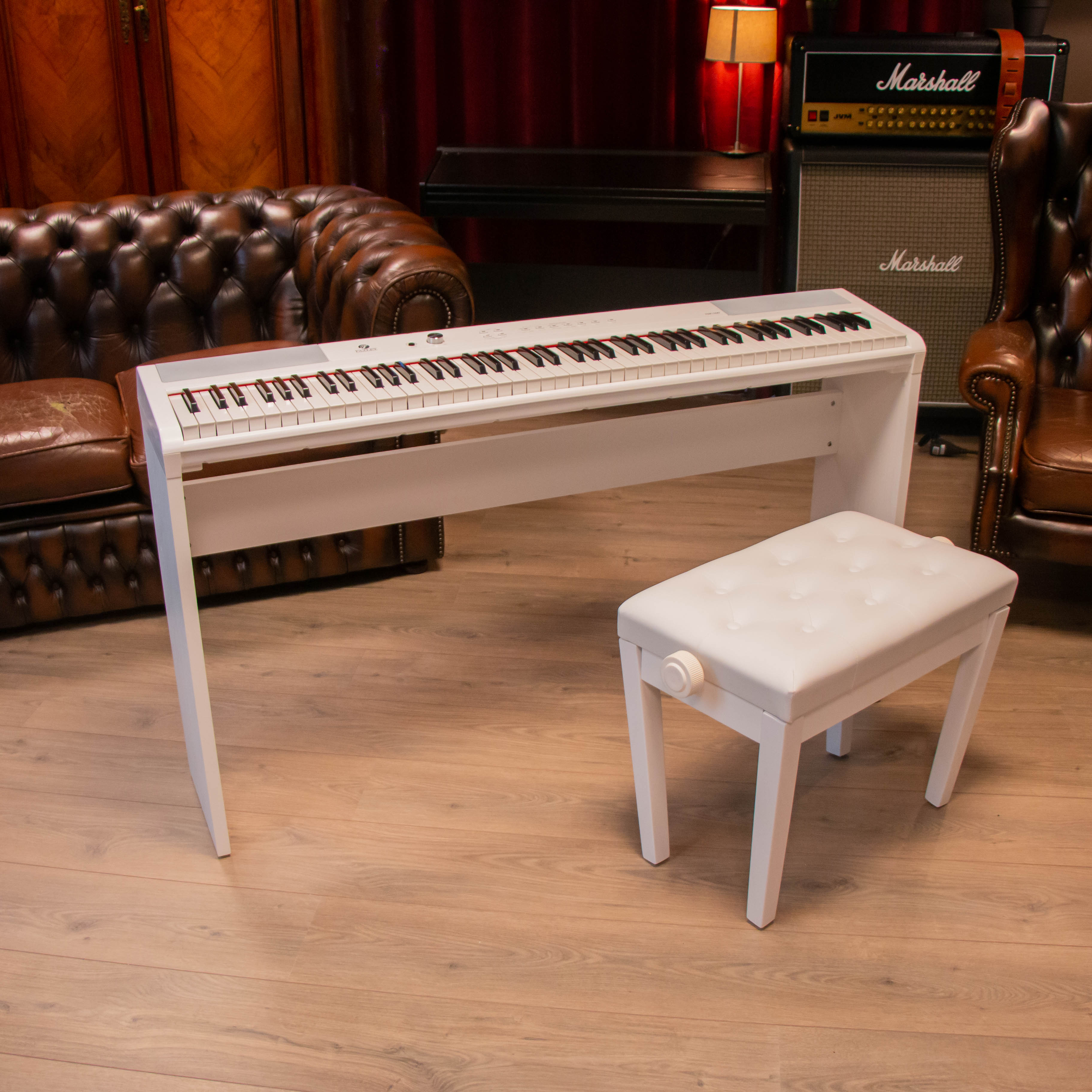 Een witte digitale piano en kruk op houten vloer, met bruine lederen meubels.