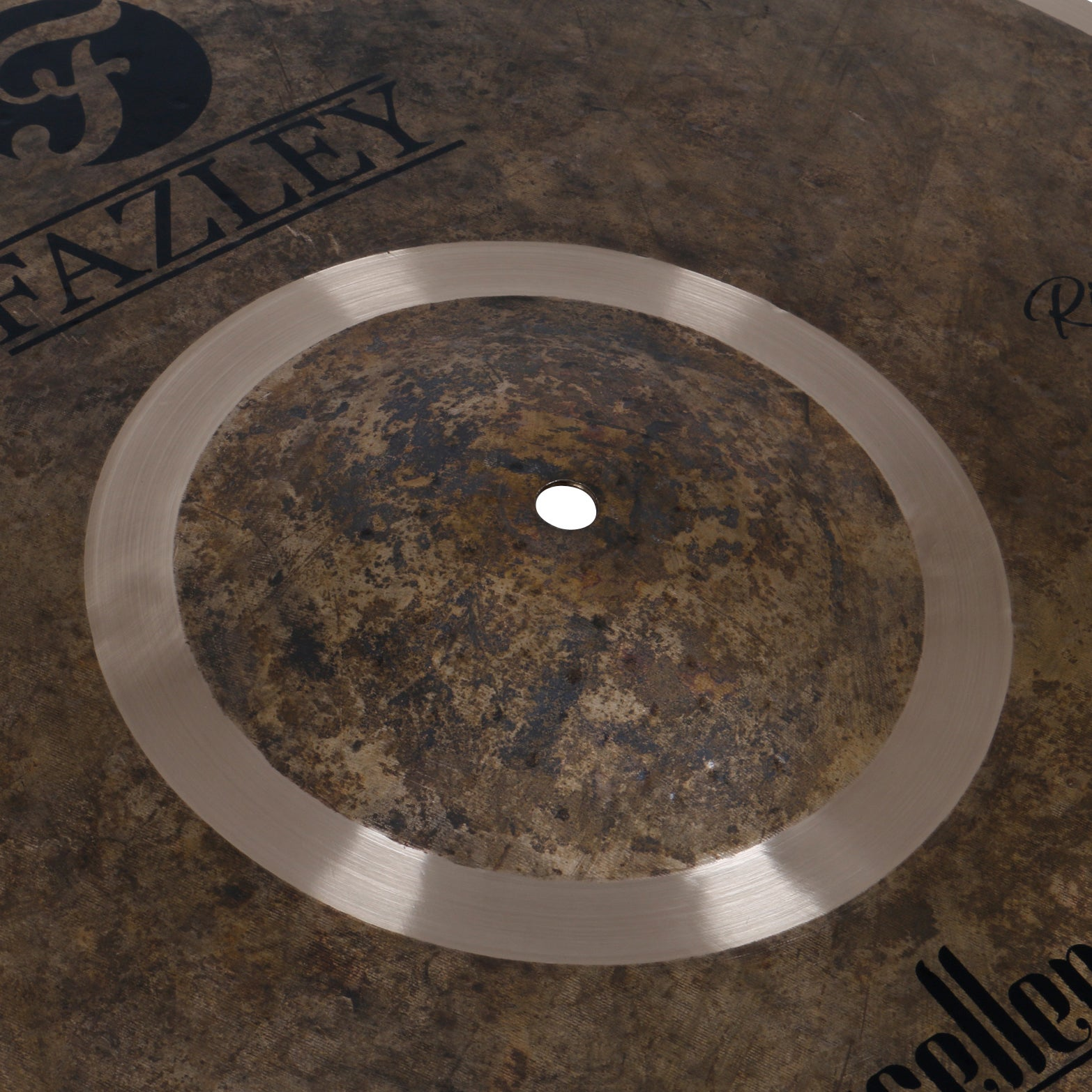 Close-up of a heavily used cymbal with brand lettering.