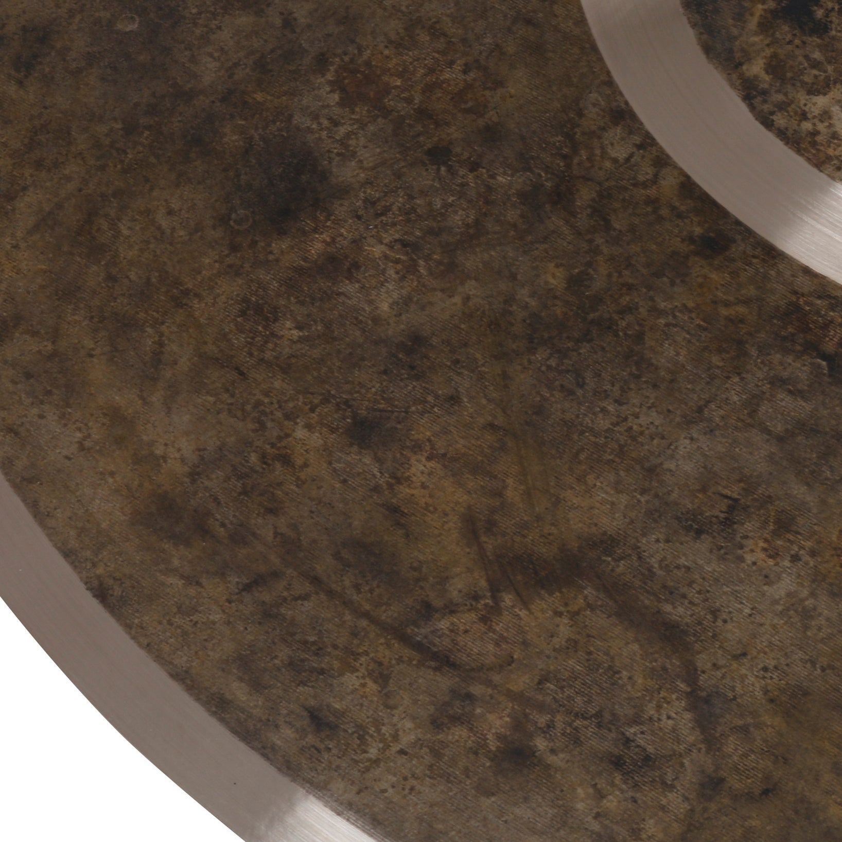 Close-up of a round, brown surface with a metallic edge.