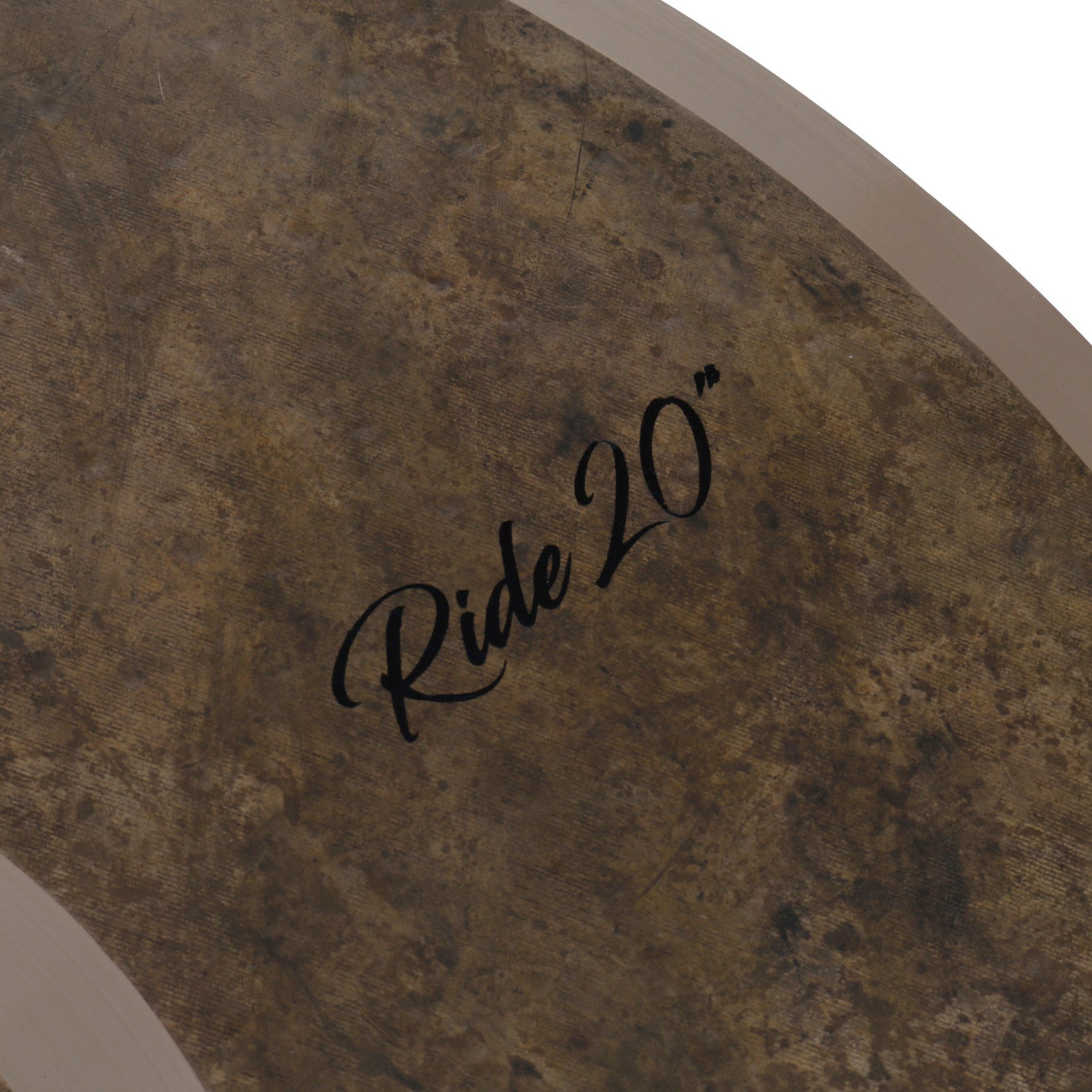 A close-up of a dark, textured cymbal with "Ride 20" written in black script.