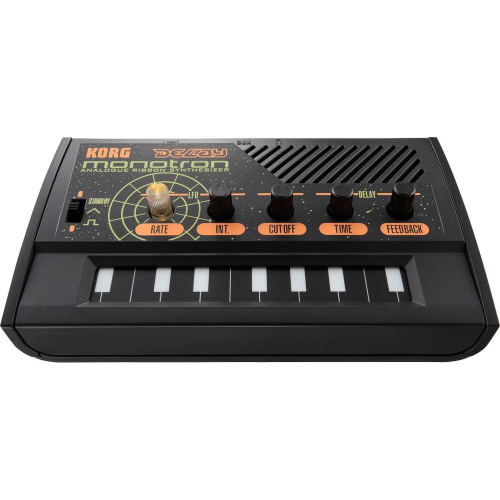 Black Korg Monotron Delay analog ribbon synthesizer with white keys and orange labels.