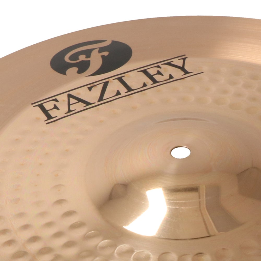 A golden cymbal with the Fazley logo and small indentations.