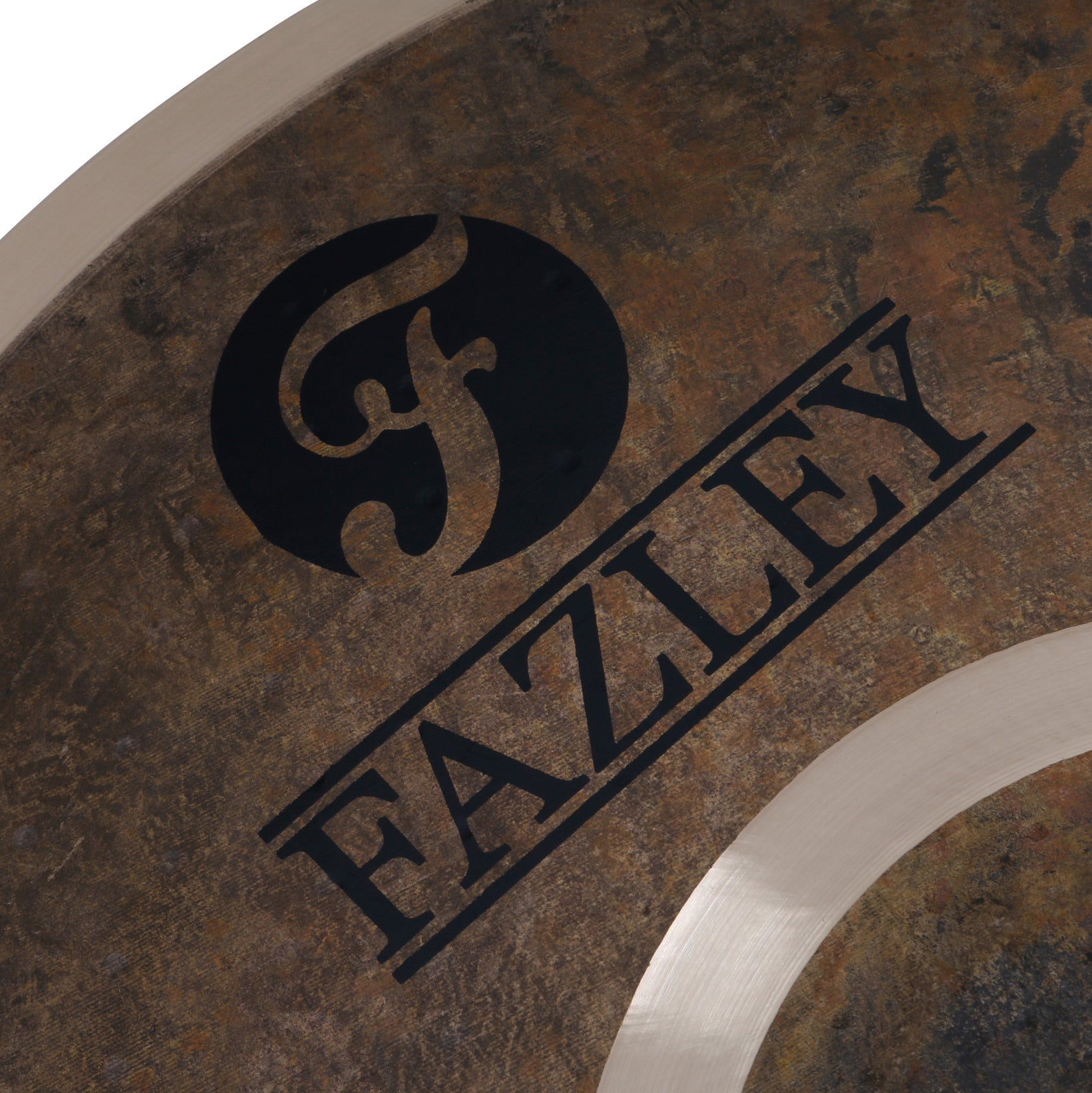 Close-up of a cymbal with a black FAZLEY logo on a textured, metallic surface.