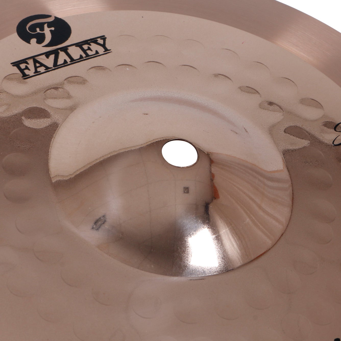 Close up of a cymbal with the Fazley logo and a hole in the center.