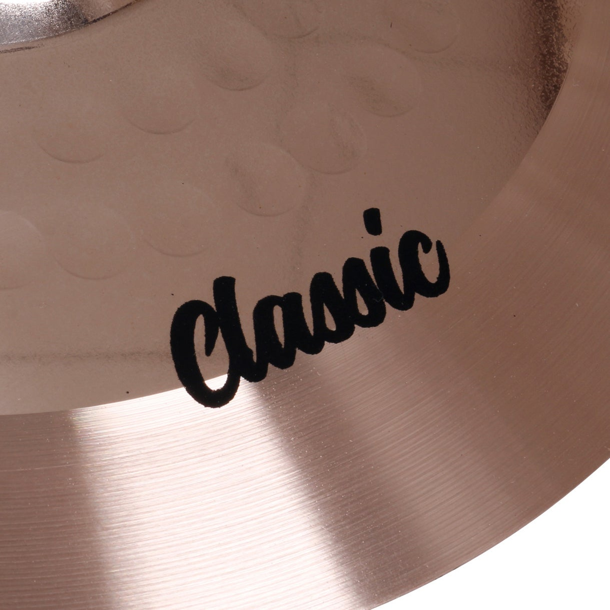 A close-up of a cymbal with the word "Classic" in black lettering.