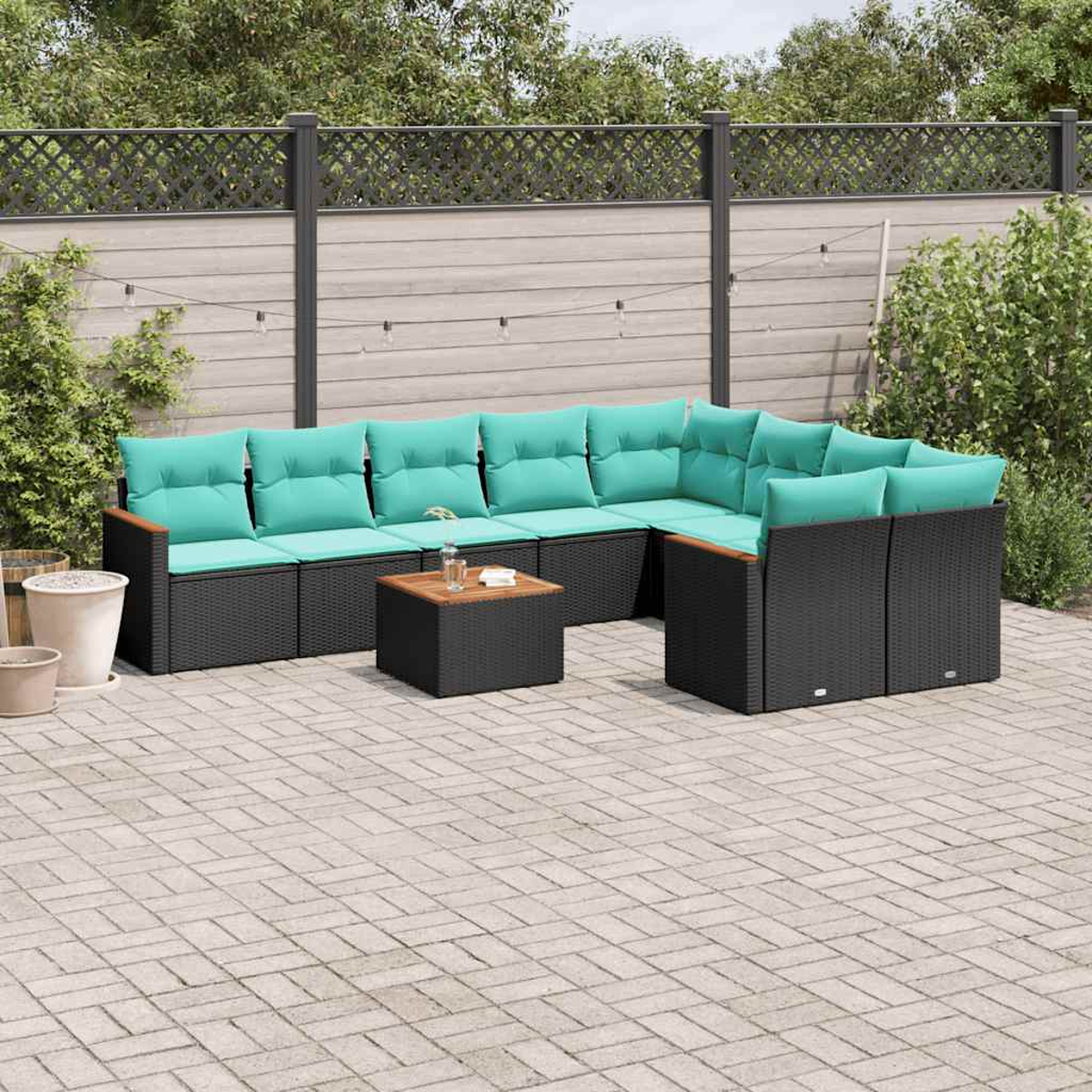 Mobiliario de exterior de ratán negro con cojines turquesa y mesa de madera.