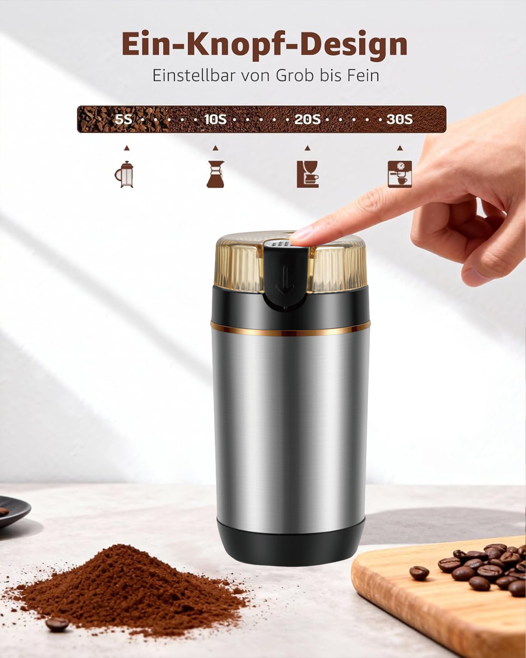 Kaffeemühle mit Knopf, daneben Kaffeepulver und Bohnen.