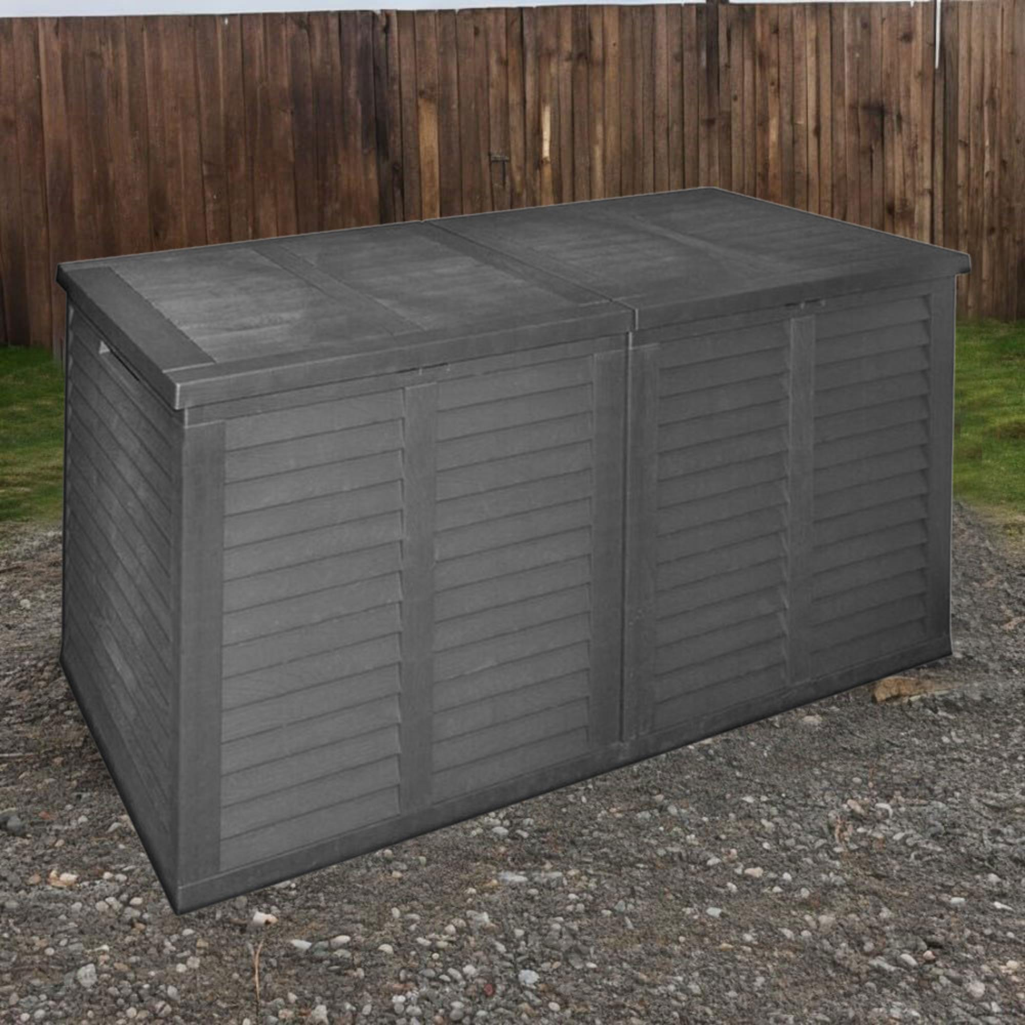 Un baúl de almacenamiento gris con puertas de lamas frente a una valla de madera.
