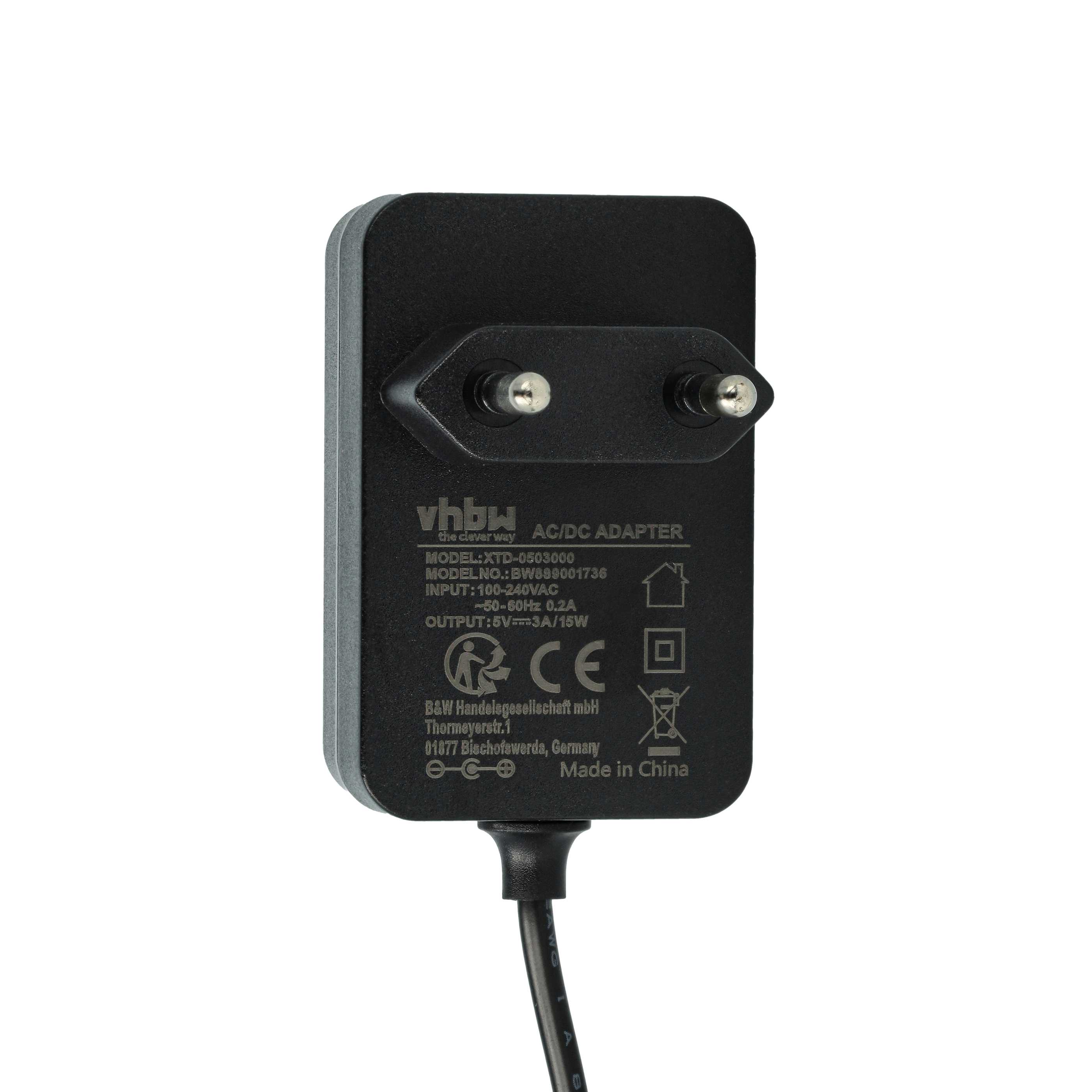 Schwarzer AC/DC-Adapter mit zwei Metallstiften und Beschriftung.