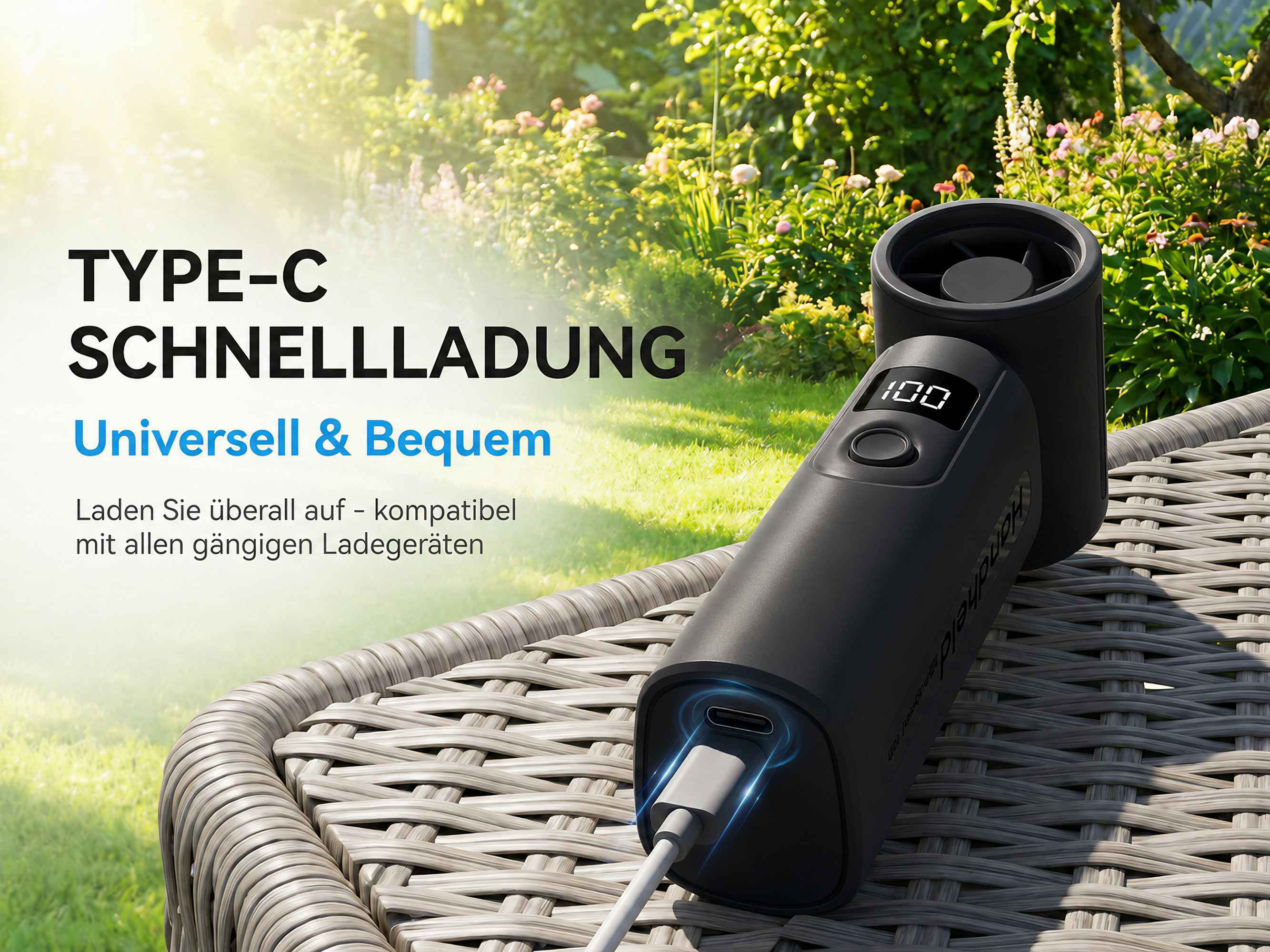 Schwarzes Ladegerät mit Type-C-Anschluss und LCD-Anzeige in einem Garten.