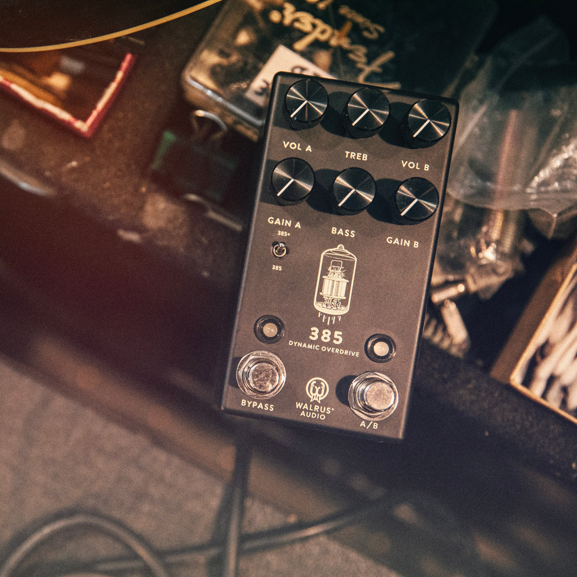 A dark overdrive pedal with silver knobs and '385' labeling.