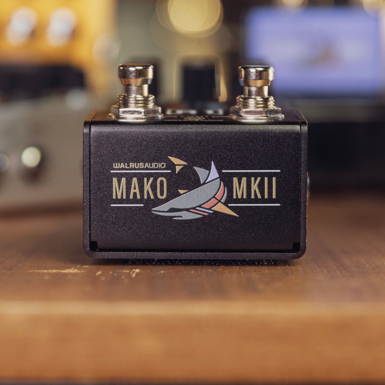 A black Walrus Audio Mako MkII pedal with switches on a wooden surface.