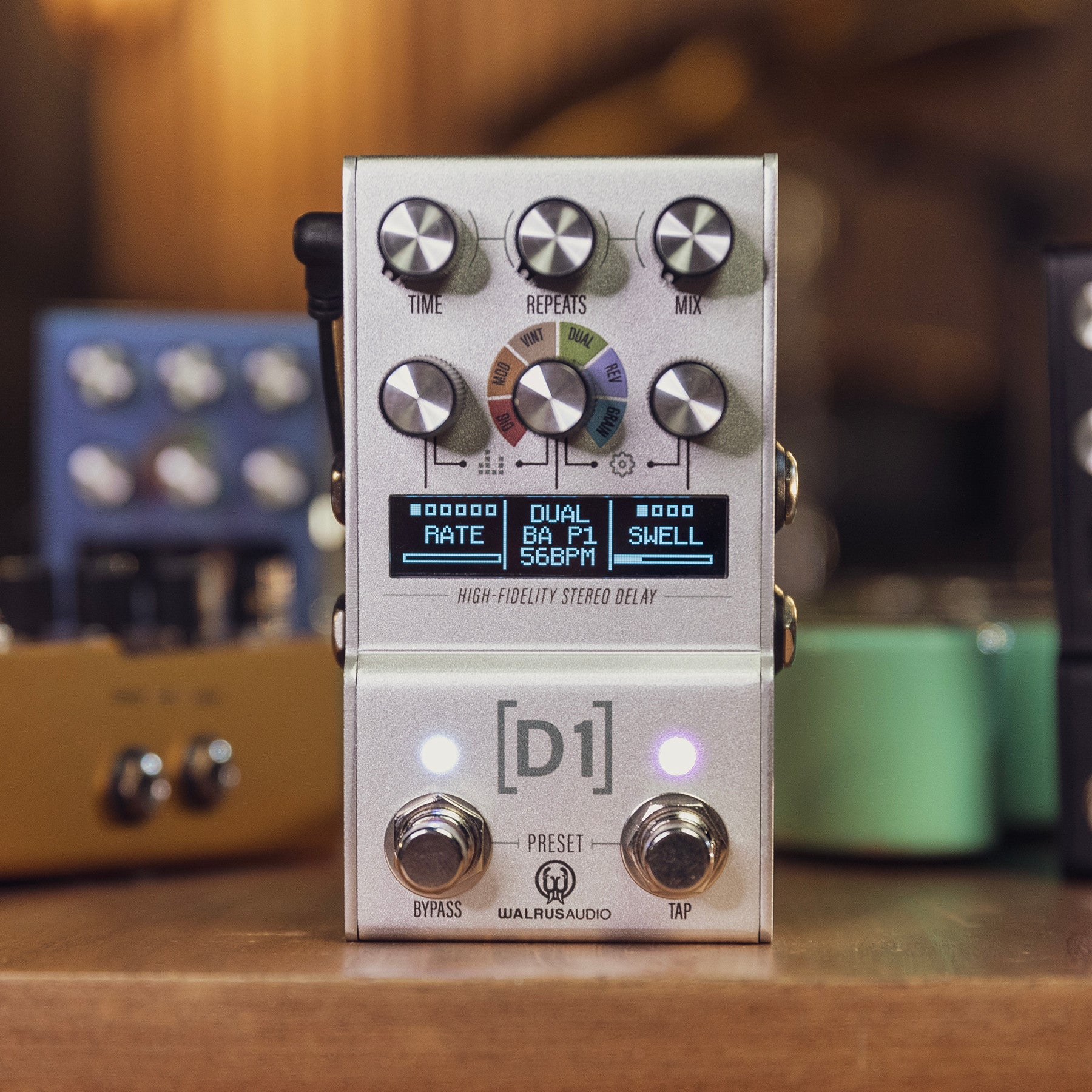 A silver stereo delay effect pedal with knobs and a display.
