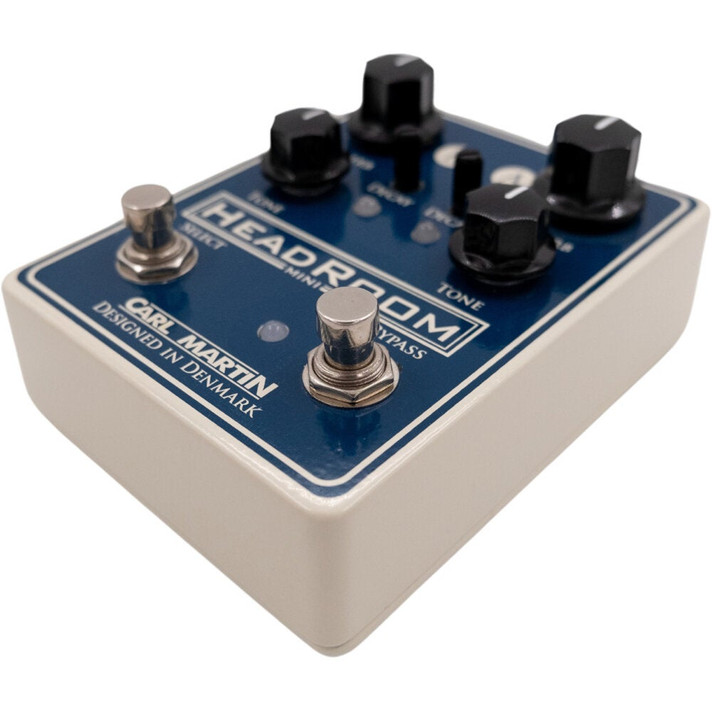 A cream-colored guitar effect pedal with a blue top and black knobs.