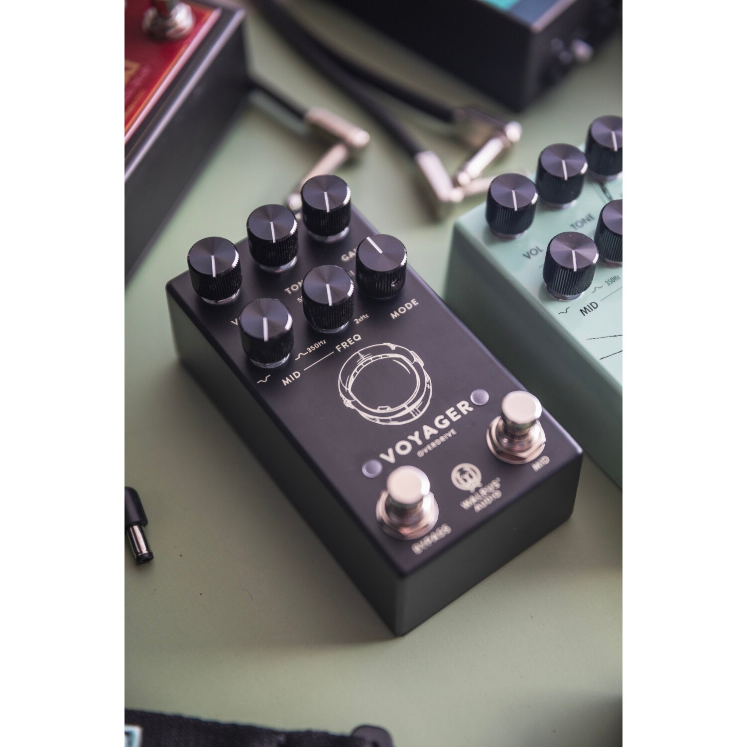 A black overdrive guitar effects pedal with knobs and labels.
