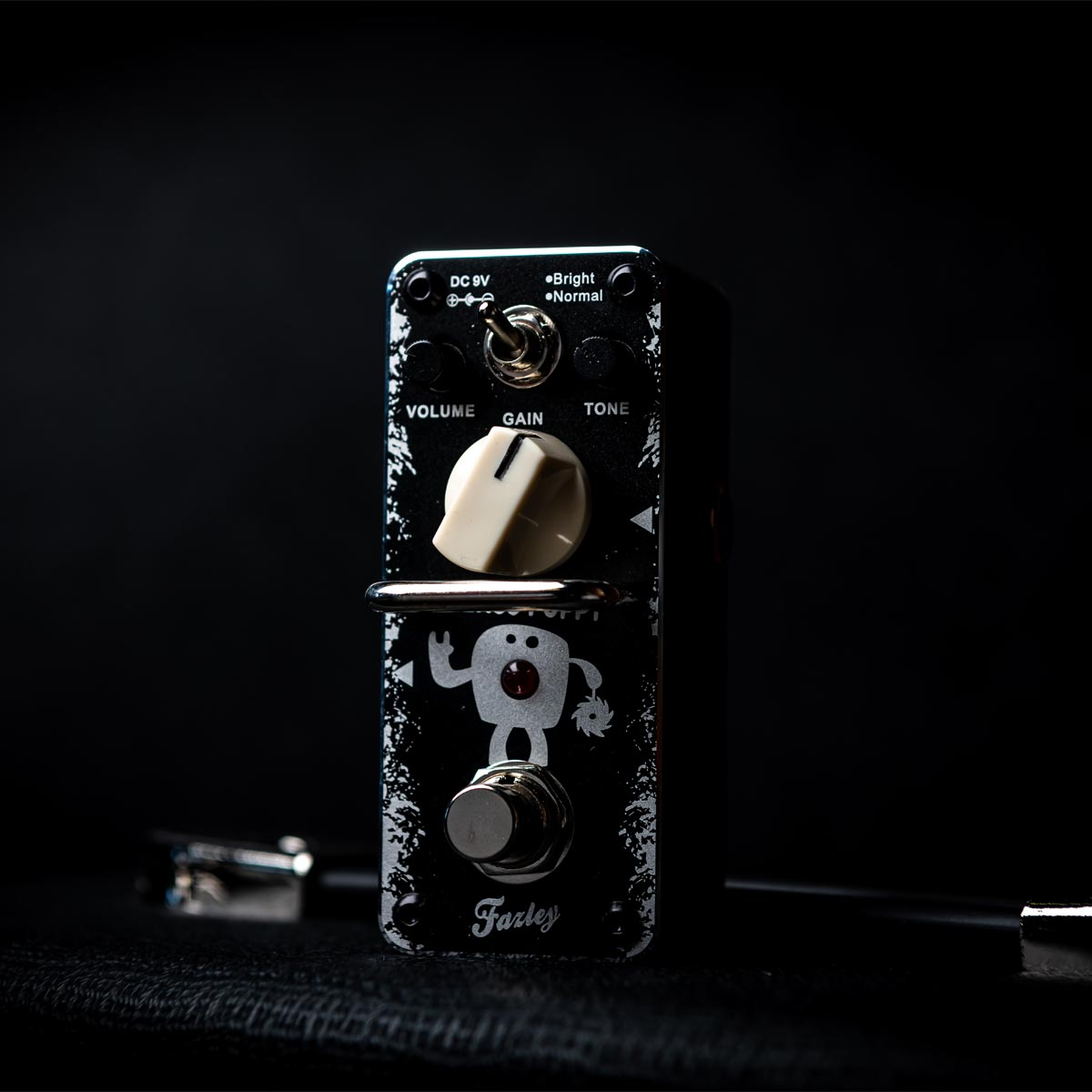 A black guitar effects pedal with white print, knobs, and switches.