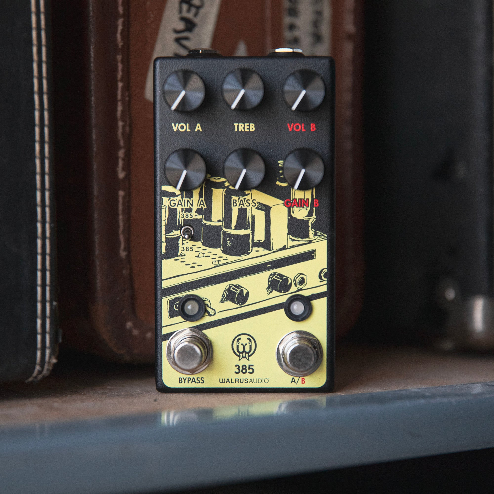 A black guitar effects pedal with yellow graphics and silver knobs.
