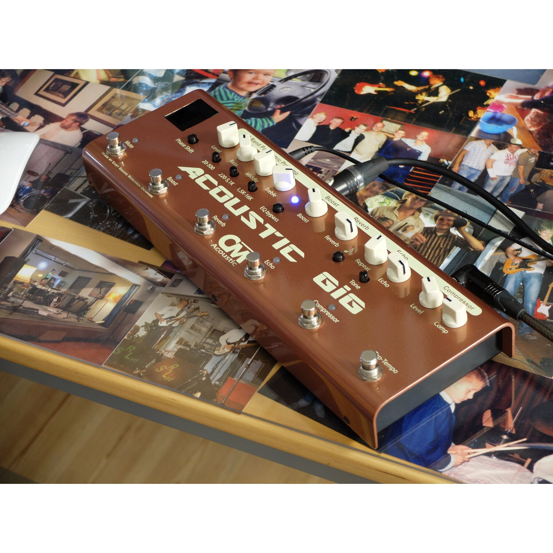 A brown guitar pedal rests on photos of people and musicians.