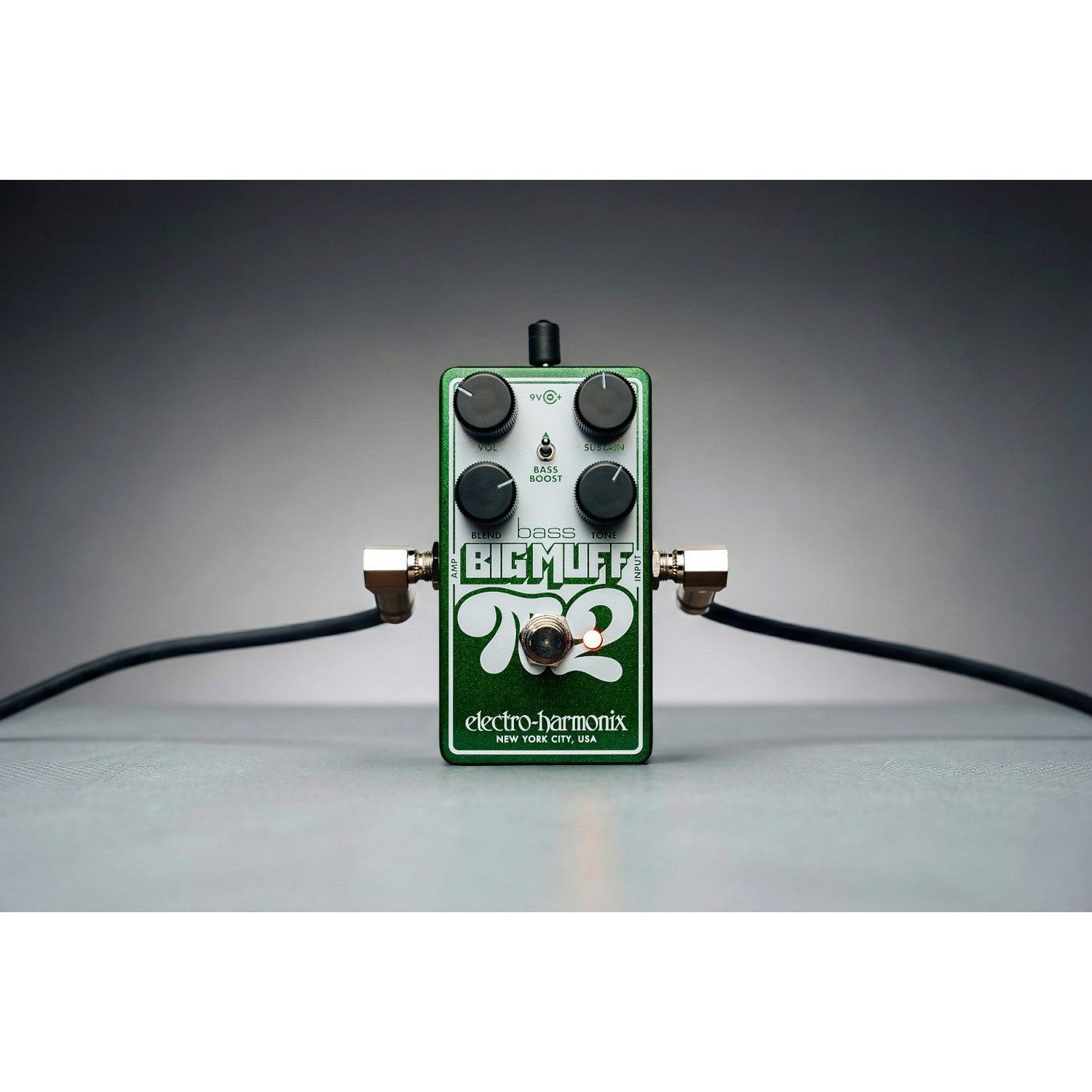 A green Electro-Harmonix Big Muff pedal with two black knobs and a footswitch.