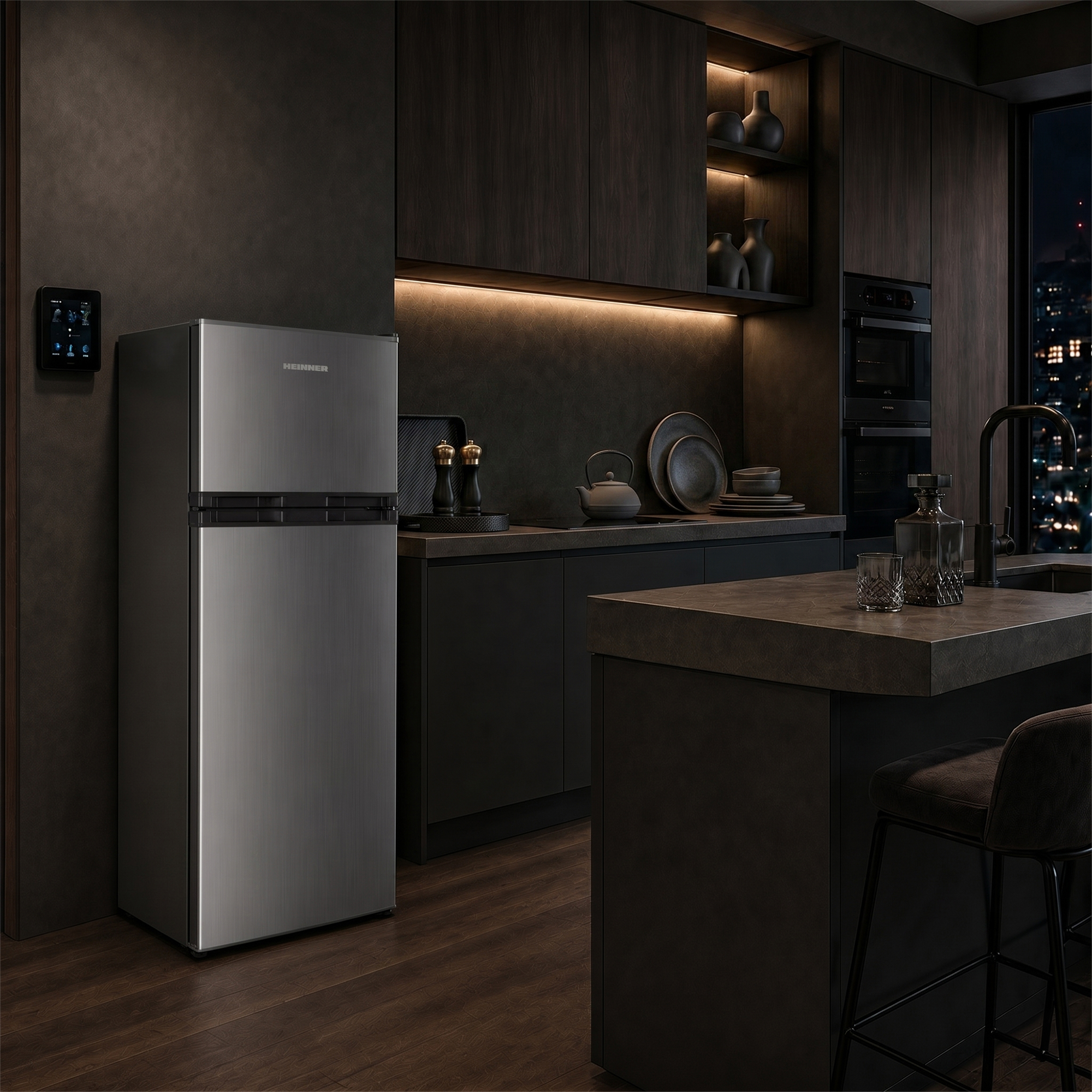 Modern kitchen with stainless steel fridge, dark cabinets, and nighttime city view.