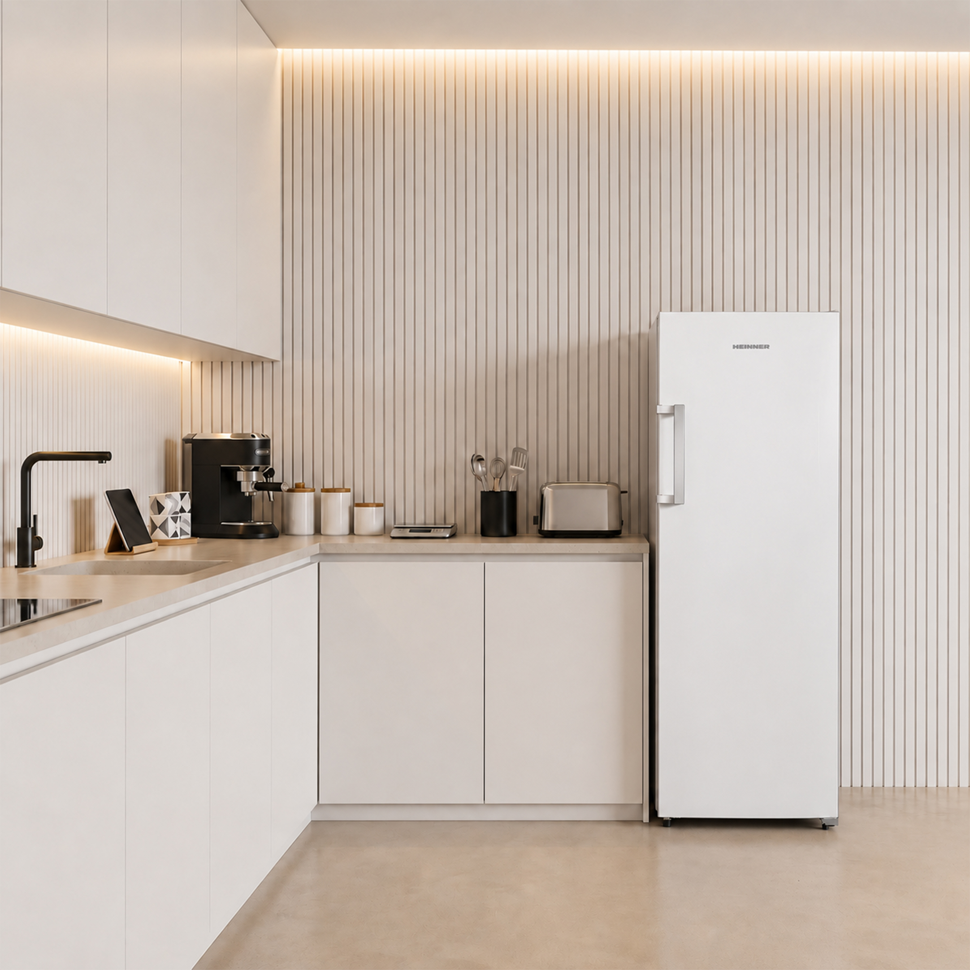 Modern white kitchen with coffee maker, toaster, fridge, and sink.