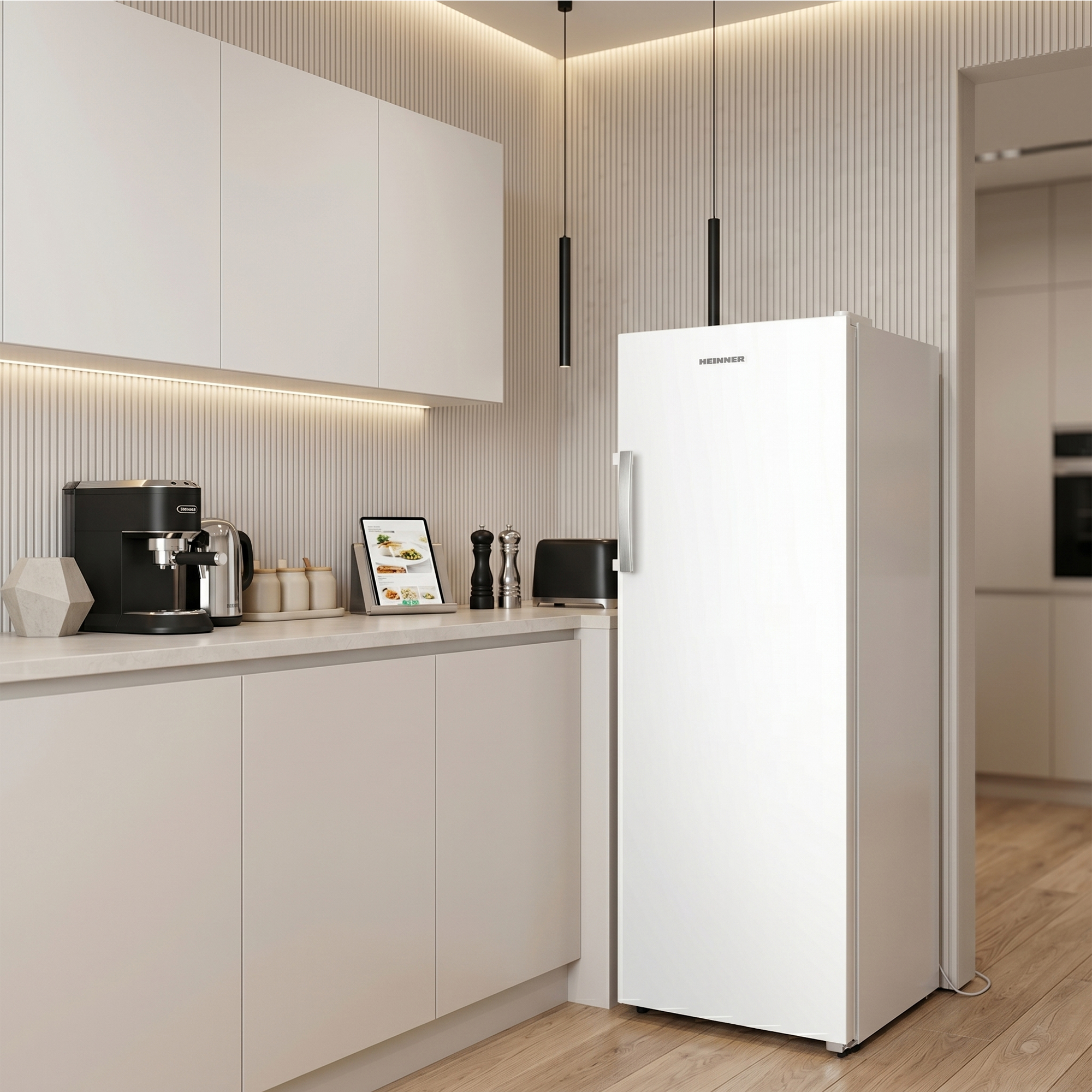 Modern kitchen with white fridge, coffee maker, toaster, and tablet on counter.